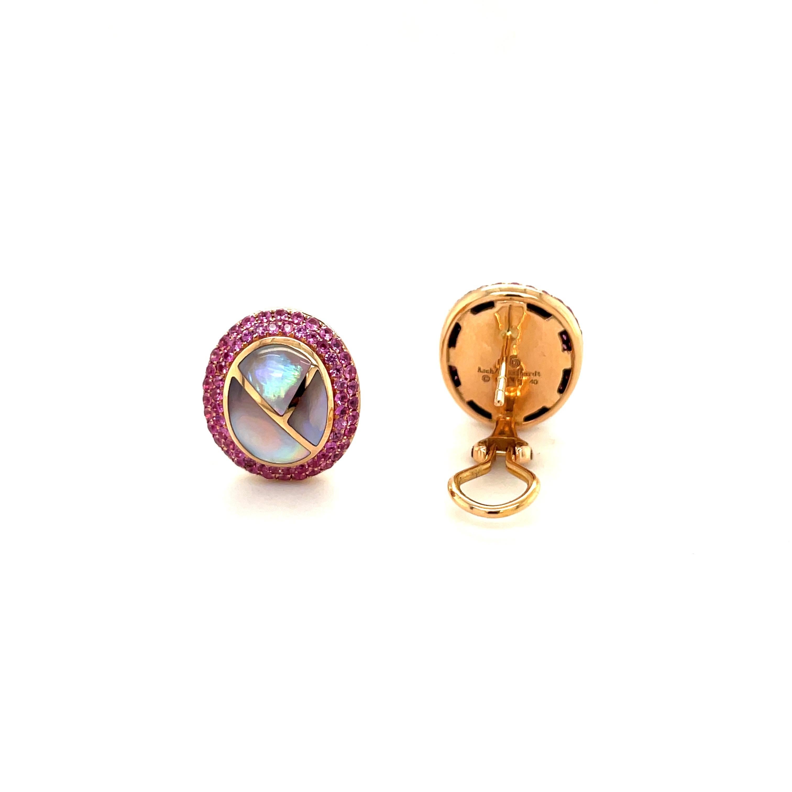 Gorgeous earrings for the pink lover. These 18 karat rose gold oval earrings are set with 2 rows of round pink sapphires. The center of the earrings have been inlaid with shapes in pink mother of pearl, giving these earrings a beautiful contrast.