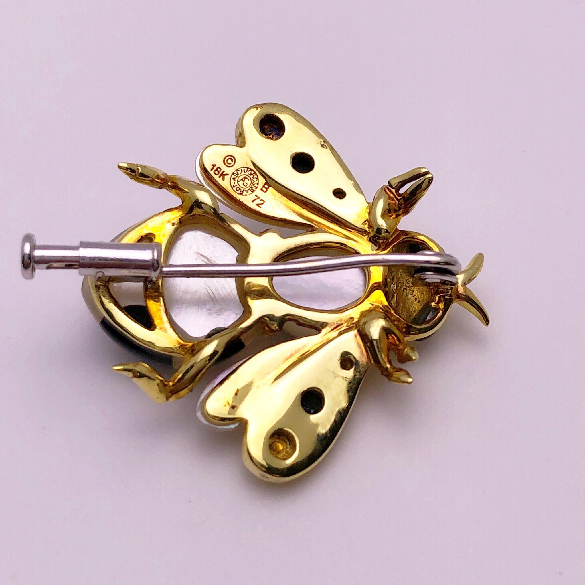This lovely bee brooch would look perfect on a lapel or a classic dress. Designed by Asch Grossbardt, the bee is a high polished 18 kt yellow gold set with white mother of pearl and black onyx. She measures 1