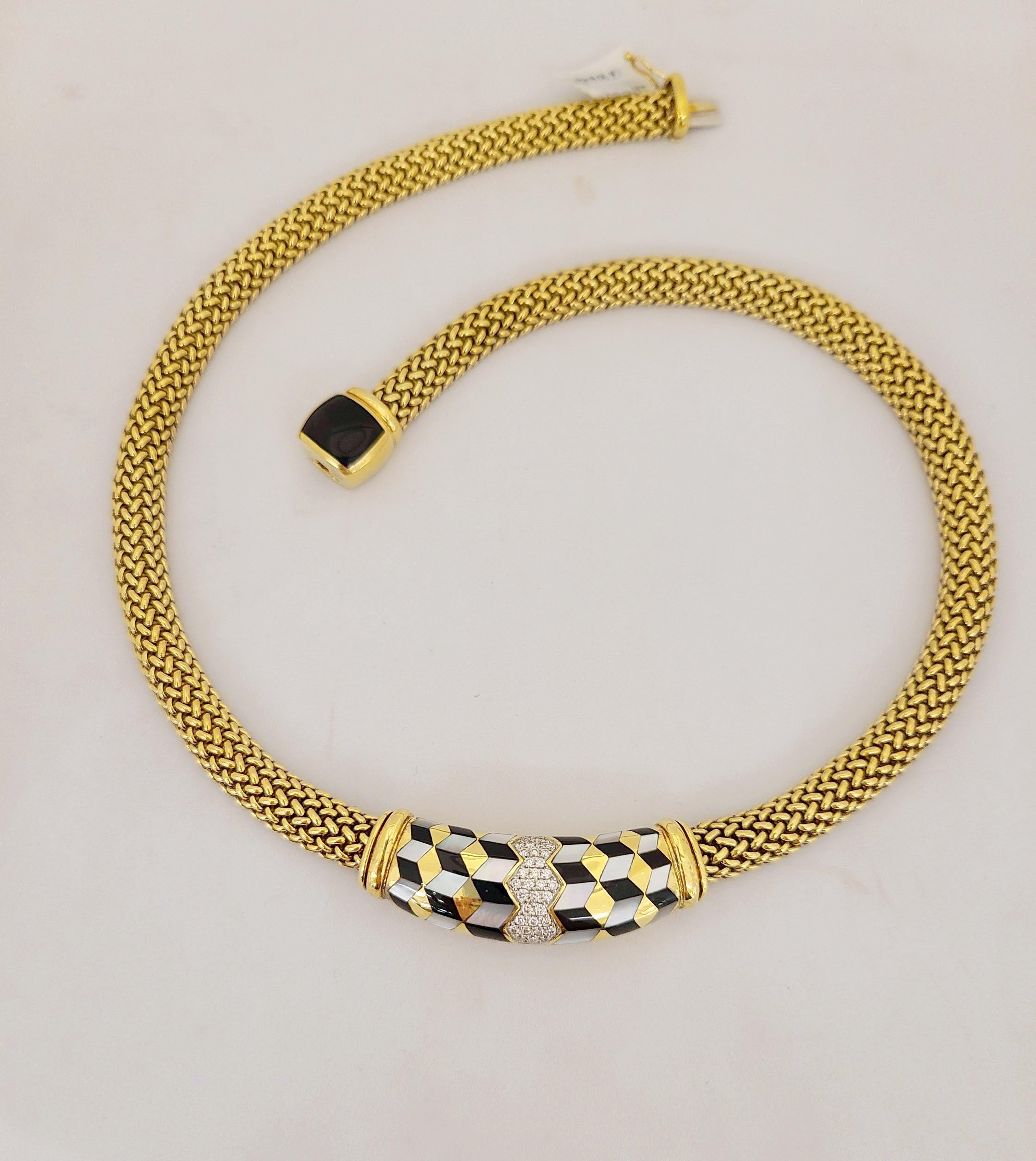 This stunning Asch Grossbardt 18 Karat yellow gold necklace is designed with a yellow gold bombe mesh chain. The centerpiece is inlaid in a geometric motif of Black Onyx,  Mother of Pearl and Diamonds. The clasp is a Black Onyx cushion motif. Total
