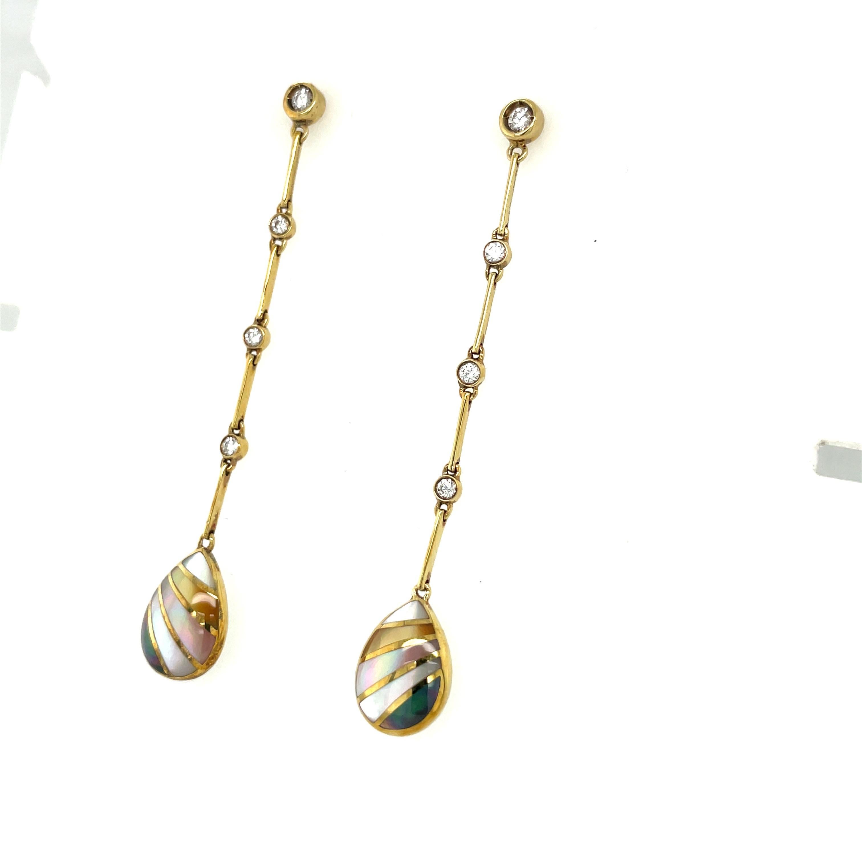 These 18 karat yellow gold hanging earrings were designed by Asch Grossbardt.  The earrings are crafted with 4 thin gold bars, joined with 4 bezel set round diamonds. A pear shaped drop of inlaid mother of pearl , in different shades, dangles at the