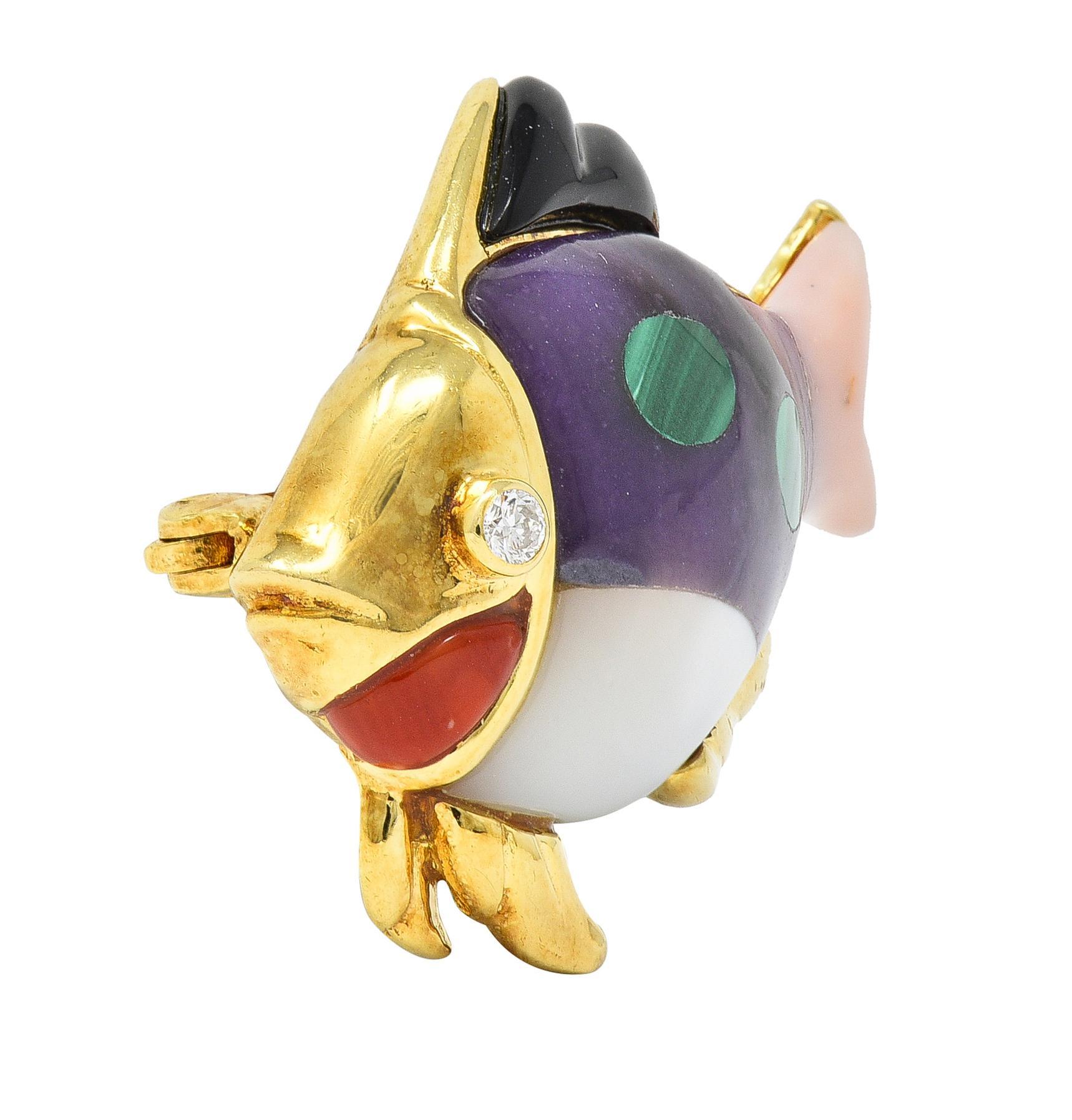 Designed as a stylized fish comprised of inlaid gemstone body and fins 
With amethyst, carnelian, malachite, mother-of-pearl, onyx, and rose quartz
Accented by a round brilliant cut diamond eye
Eye clean and bright - bezel set 
With grooved gold