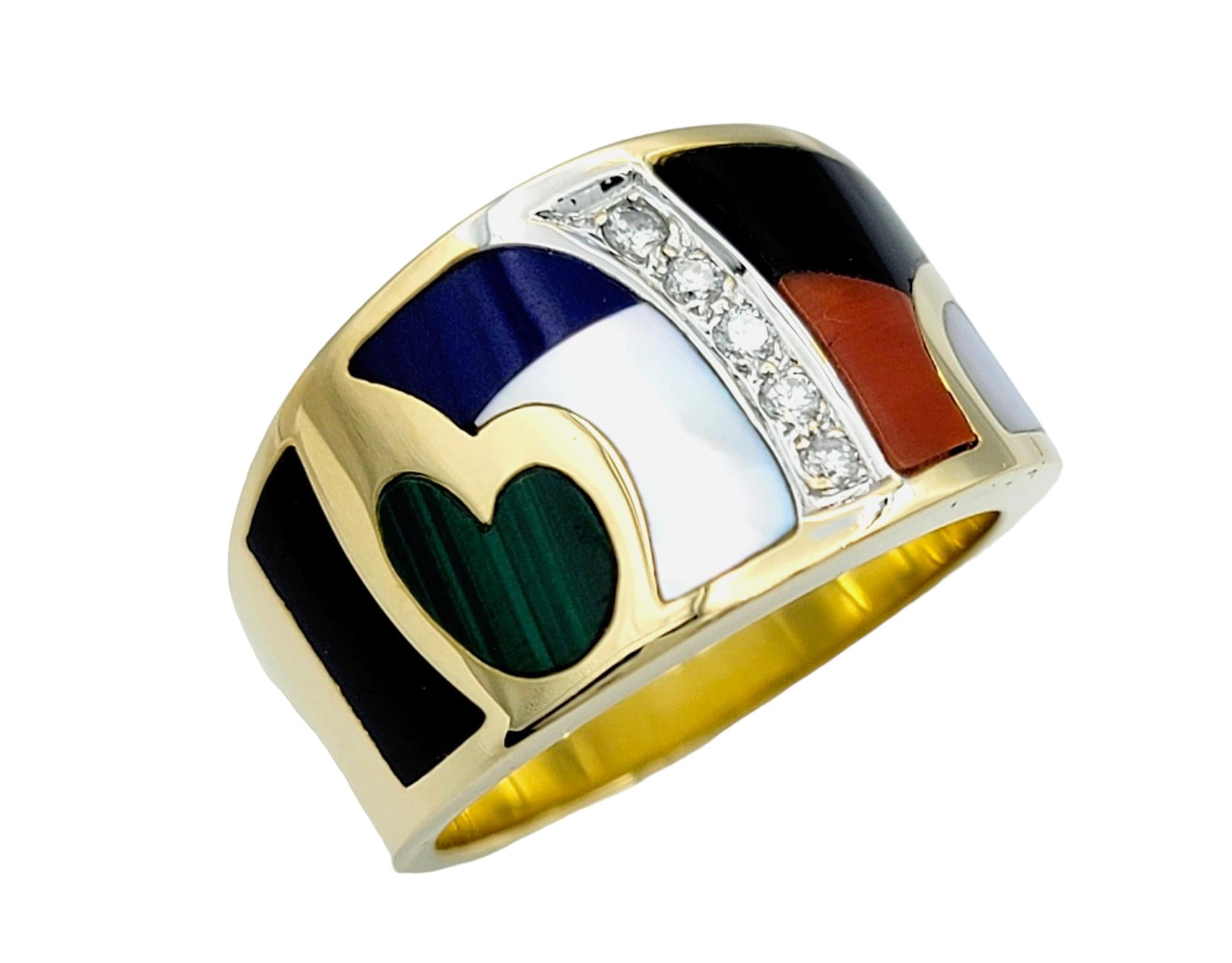 Ring Size: 6.75 

This beautiful Asch Grossbardt band ring is a masterpiece of color and craftsmanship, set in radiant 18 karat yellow gold. Its distinctive feature lies in its captivating inlay of colorful gemstones, carefully arranged to form a