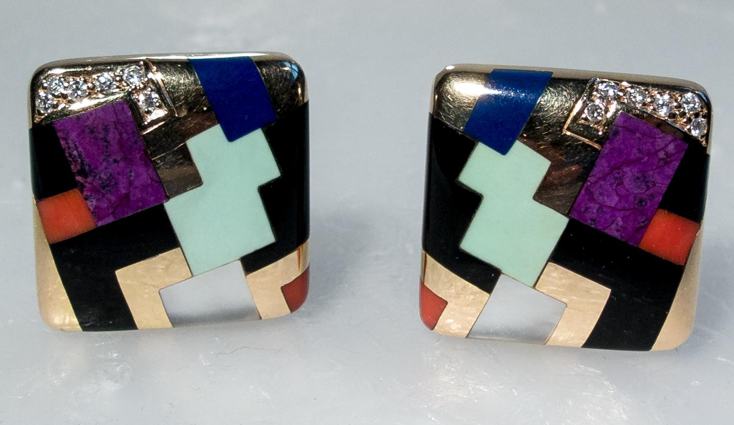 Typical of the colorful inlay work of the American jeweler Asch Grossbardt, these earclips are set with panels of lapis lazuli, onyx, orange coral, green turquoise, purpurine, and a sprinkle of diamonds at the corners.  They measure 14/16