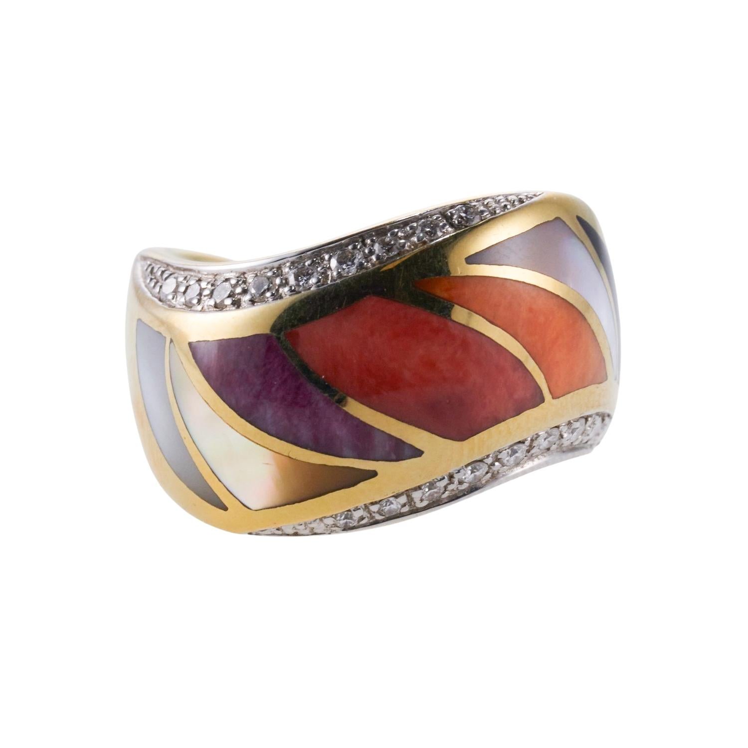 A 14k yellow gold ring set with inlay coral, MOP, sugilite and approx. 0.09ctw H/VS diamonds. Ring size 6.5, top is 13mm wide. 12.8 grams.