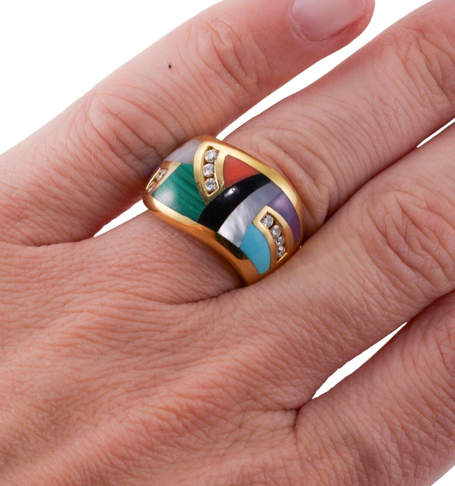 A 14k yellow gold ring set with mother-of-pearl, coral, lapis, malachite, turquoise, purple sugilite and diamonds - approx. 0.31ctw. Ring Size 6.25, 14mm Wide. 12.7 grams.