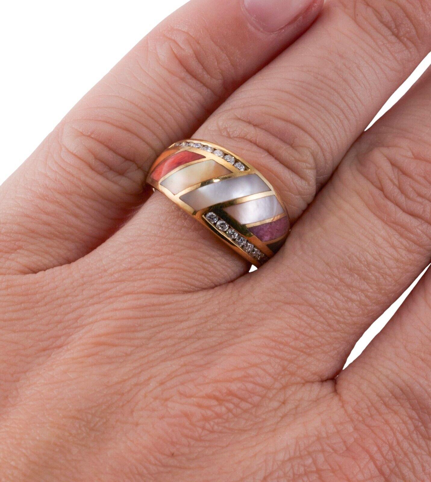 A 14k yellow gold ring set with mother-of-pearl, coral, purple sugilite and diamonds - approx. 0.16ctw. Ring Size 6.25, 10.5mm wide. 8 grams.