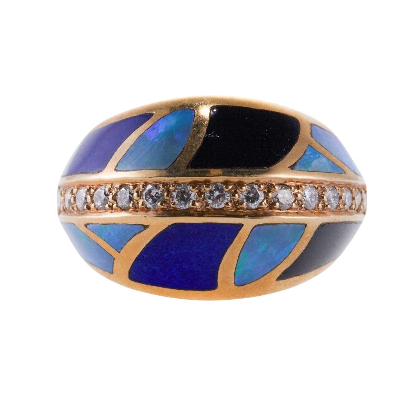 A 14k yellow gold ring set with mother-of-pearl, lapis, onyx, opal and diamonds. Diamonds - approx. 0.30ctw. Ring Size 6.75, 15mm wide. 9.5 grams.