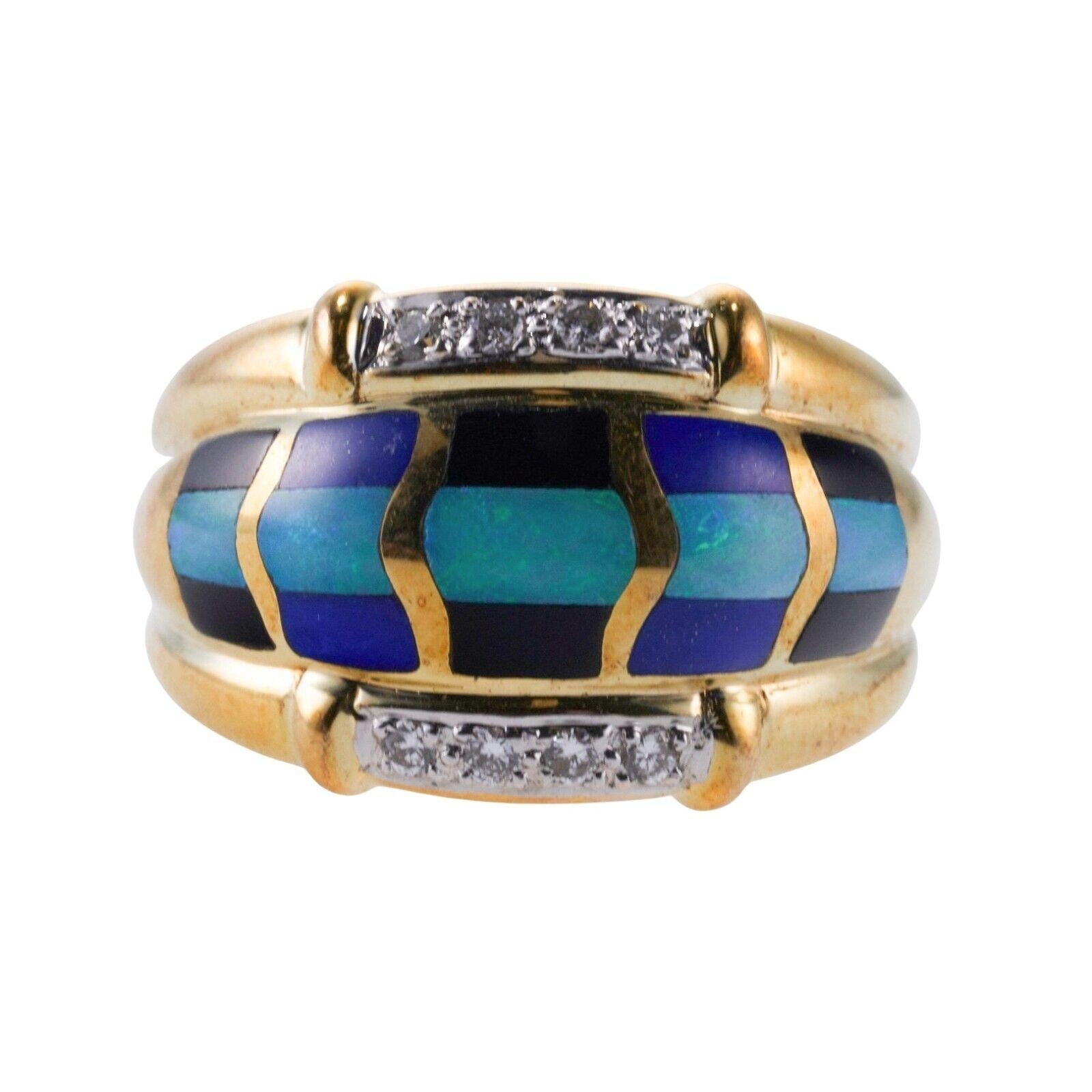 A 14k yellow gold ring set with mother-of-pearl, onyx, lapis, opal, and diamonds - approx. 0.08ctw. Ring Size 8, 15mm wide. 10.8 grams.