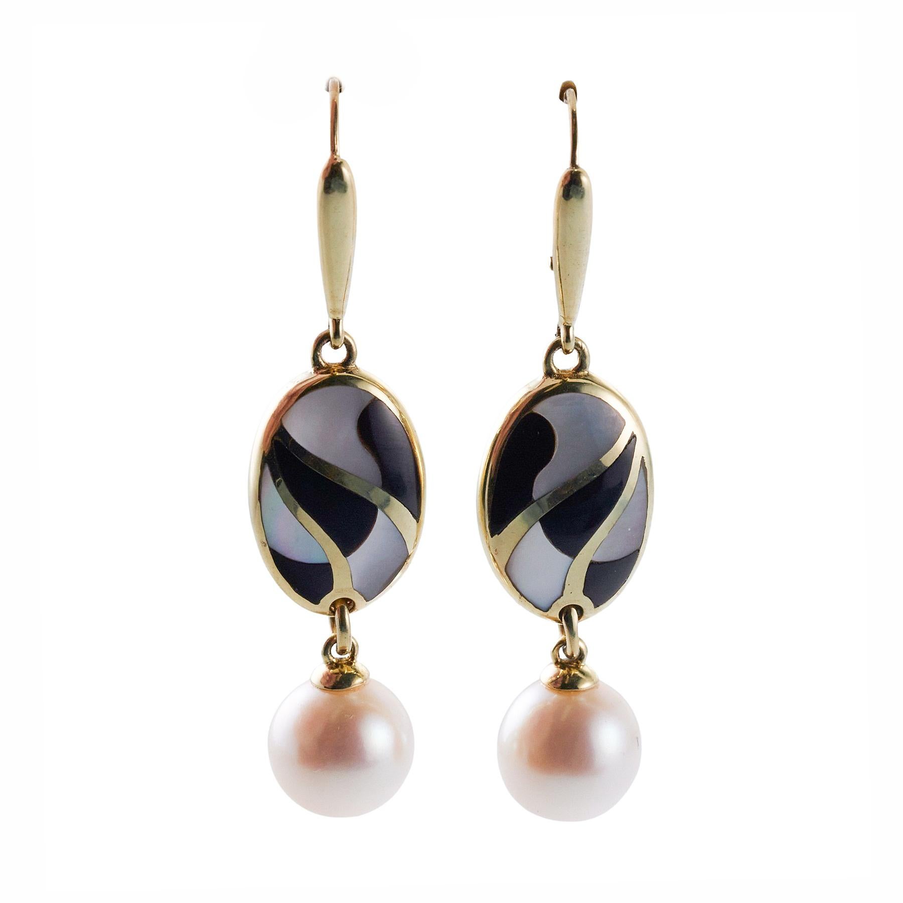 Pair of 14k gold Asch Grossbardt earrings, with 8.5mm pearls, inlay mother of pearl and onyx. Earrings are 45mm long. 6.5 grams.