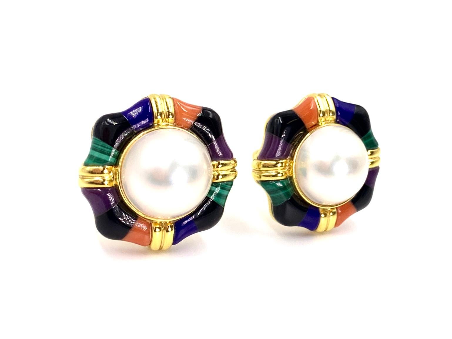 Beautiful large button style 14 karat yellow gold Asch Grossbardt earrings featuring a natural ivory 15mm mabe pearl surrounded by exquisitely-executed inlaid stones. Stones include coral, lapis, onyx, malachite and purple sugilite. Earrings are