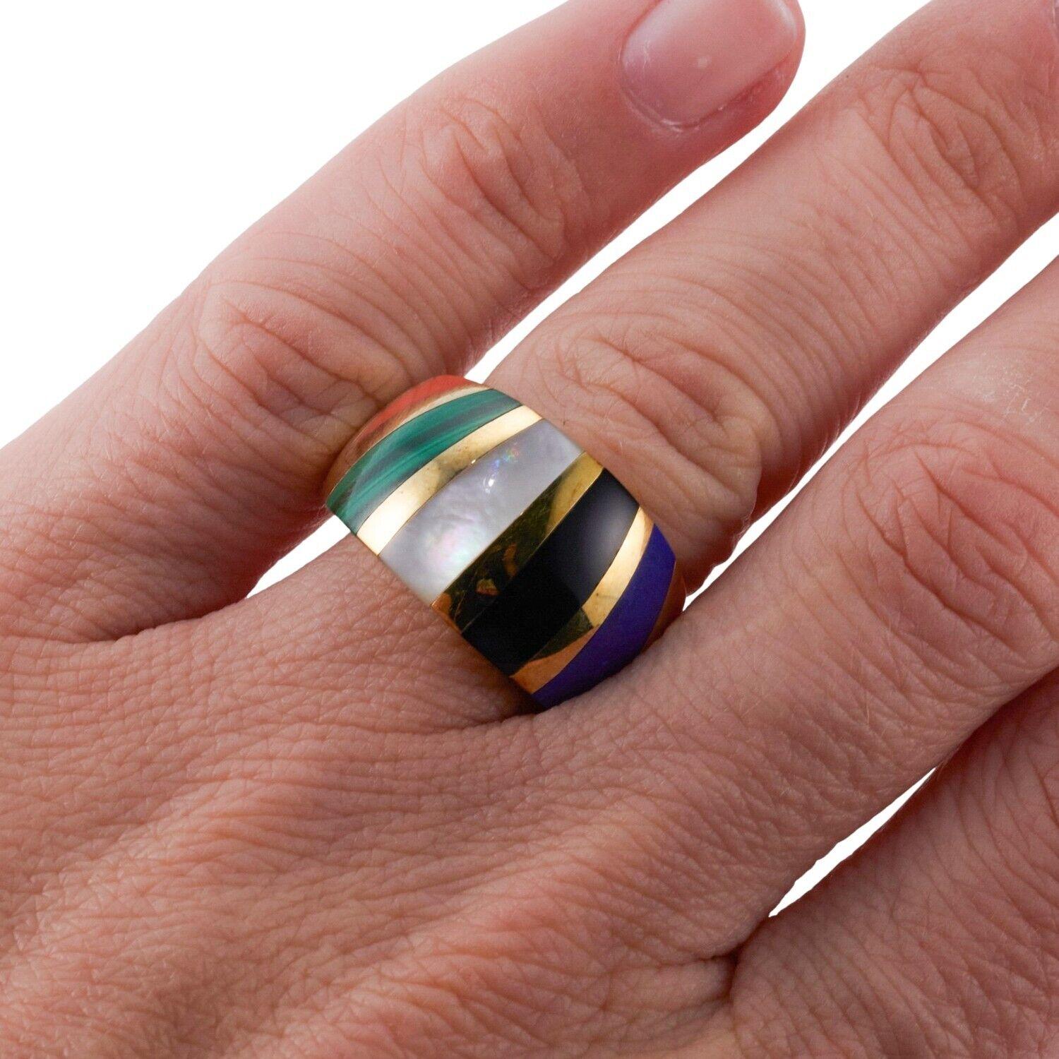 A 14k yellow gold ring set with mother-of-pearl, coral, malachite, lapis and onyx. Ring Size 6.5, 13.5mm wide. 11.8 grams.
