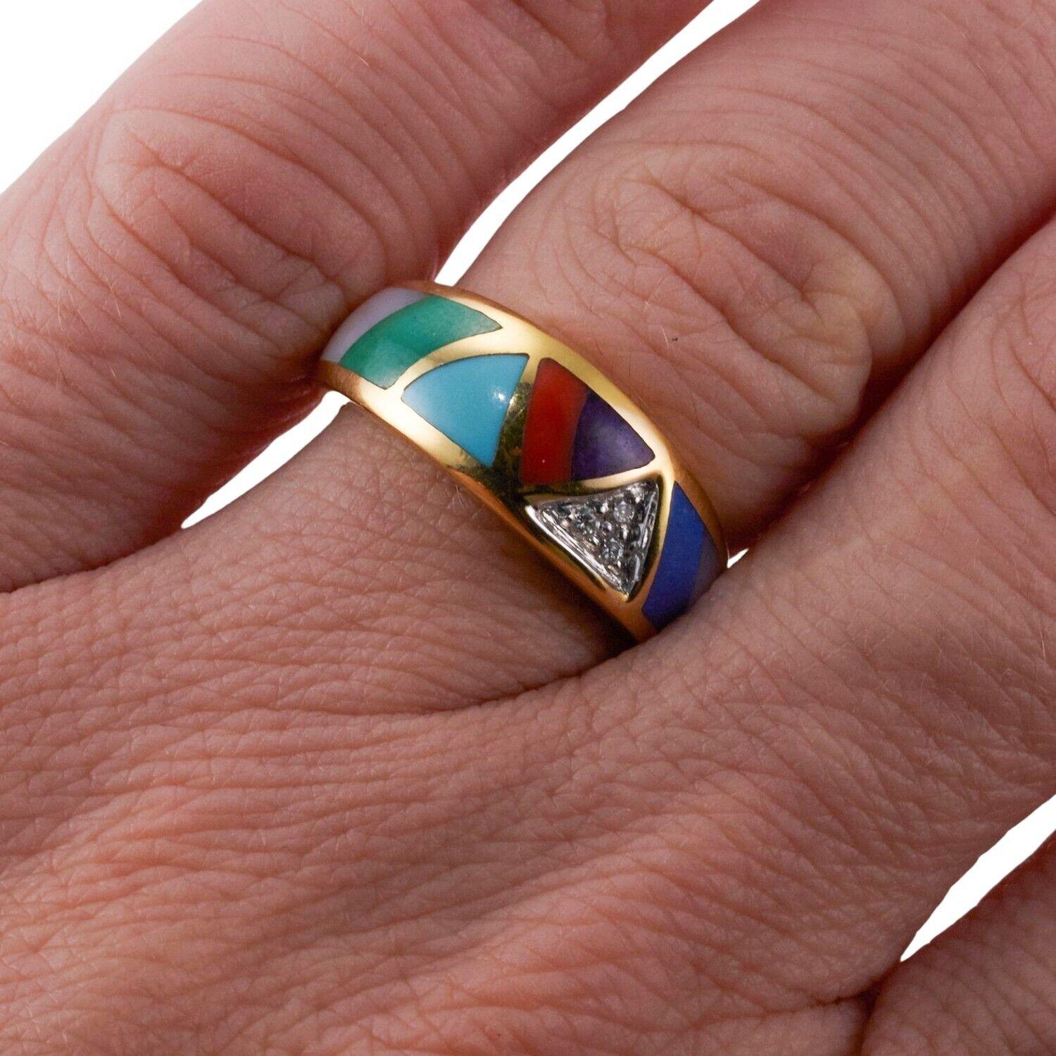 A 14k yellow gold ring set with mother-of-pearl, turquoise, coral, lapis, malachite, purple sugilite, and diamonds. Mother-of-Pearl, Turquoise, Coral, Lapis, Malachite, Purple Sugilite, Diamonds - approx. 0.03ctw. 5 grams.
