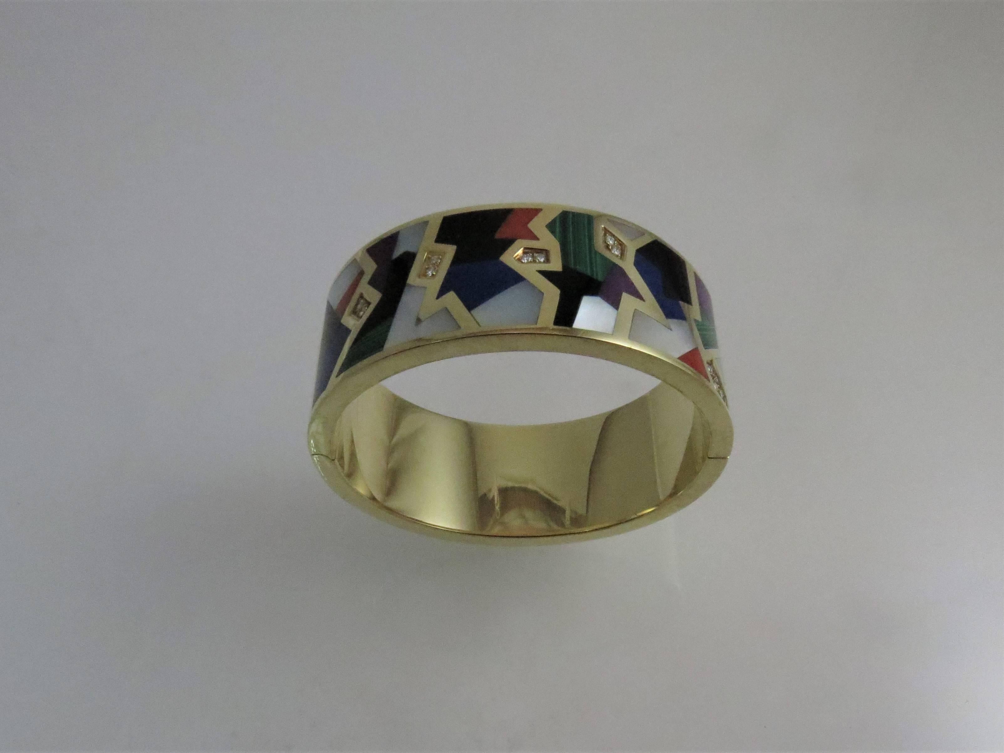 14K yellow gold, Asch Grossbardt bangle bracelet with hinge, inlaid with black onyx, mother of pearl, lapis, coral, malachite, sugilite and 12 full cut round diamonds weighing .24cts, G-H color, VS clarity
Last retail: 10,500