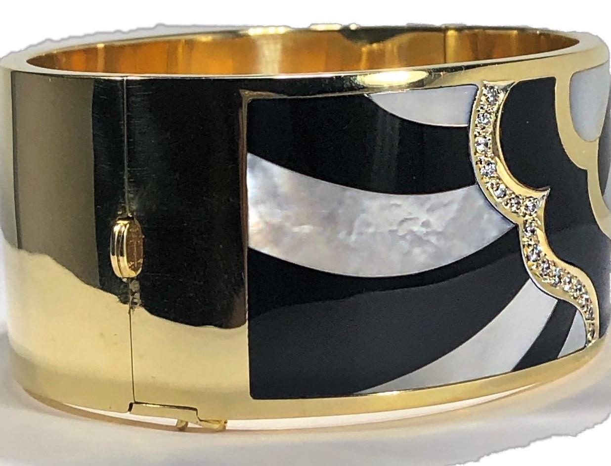 Cut with precision, the onyx and mother of pearl swirl patterns are set into this 1 3/16