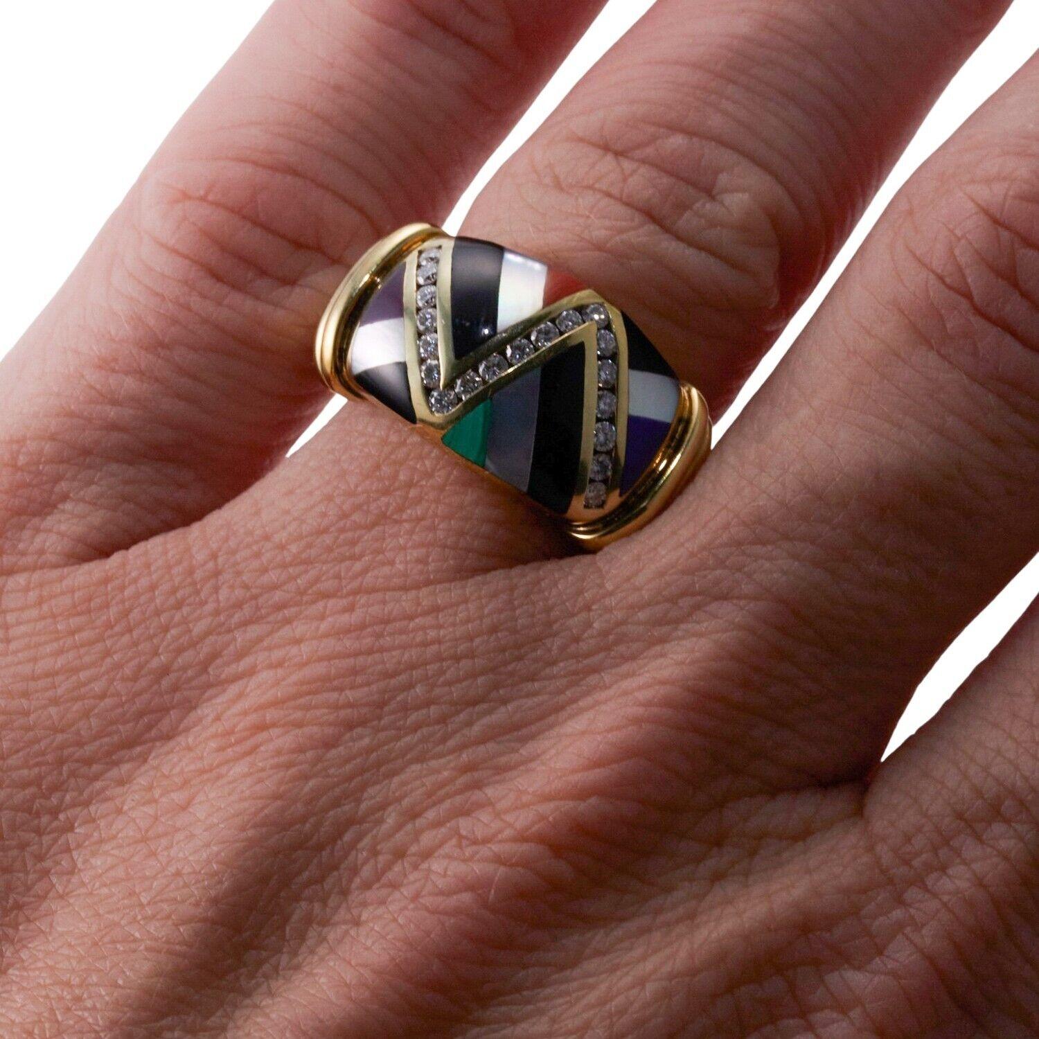 A 14k yellow gold ring set with mother-of-pearl, coral, malachite, purple sugilite, onyx and diamonds - approx. 0.28ctw. Ring Size 6.5, 12mm wide. 9.7 grams.