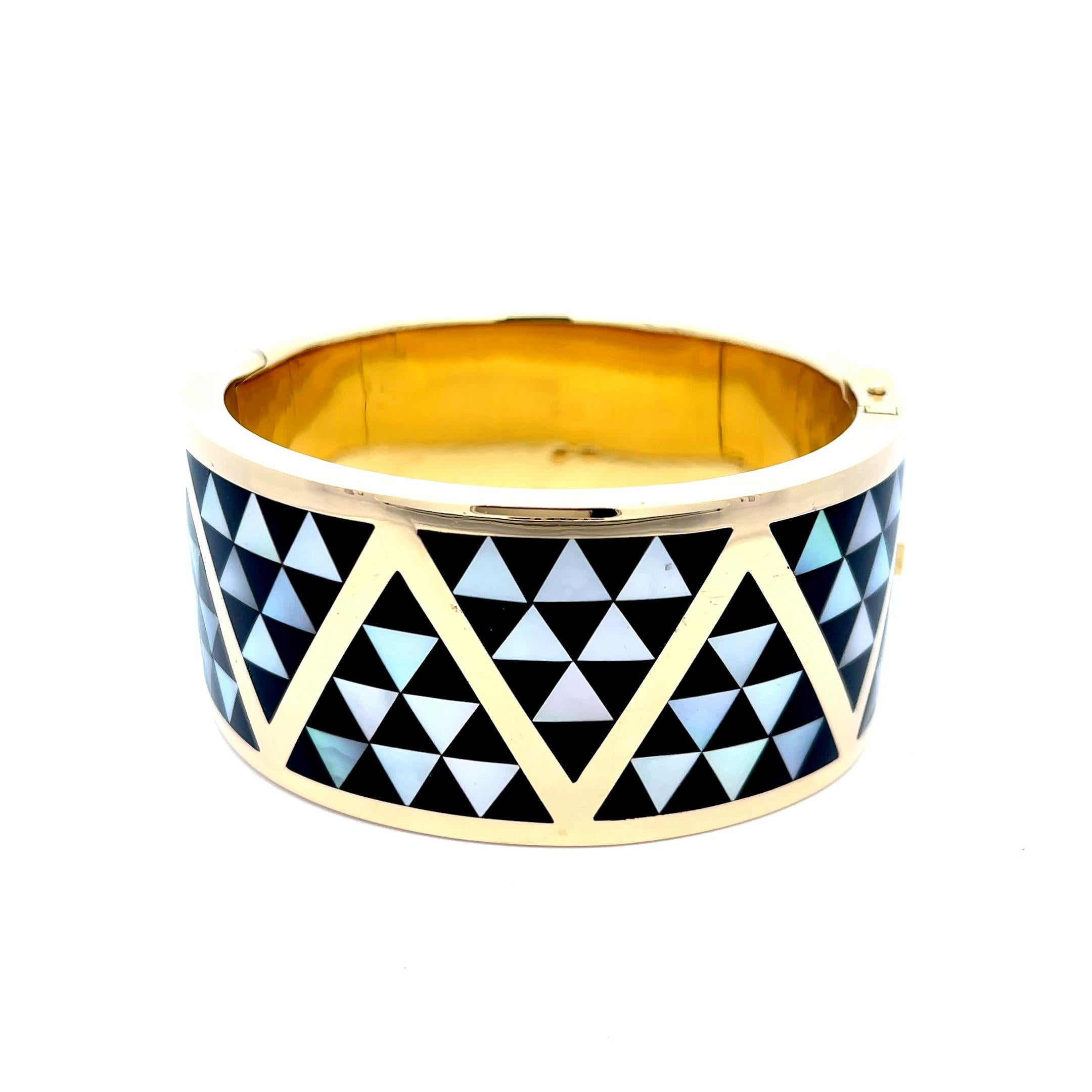 Asch Grossbardt Onyx and Mother-of-Pearl Cuff in 18K Yellow Gold. The cuff features inlays of triangular shape mother -of-pearl and onyx. The cuff is 1.25
