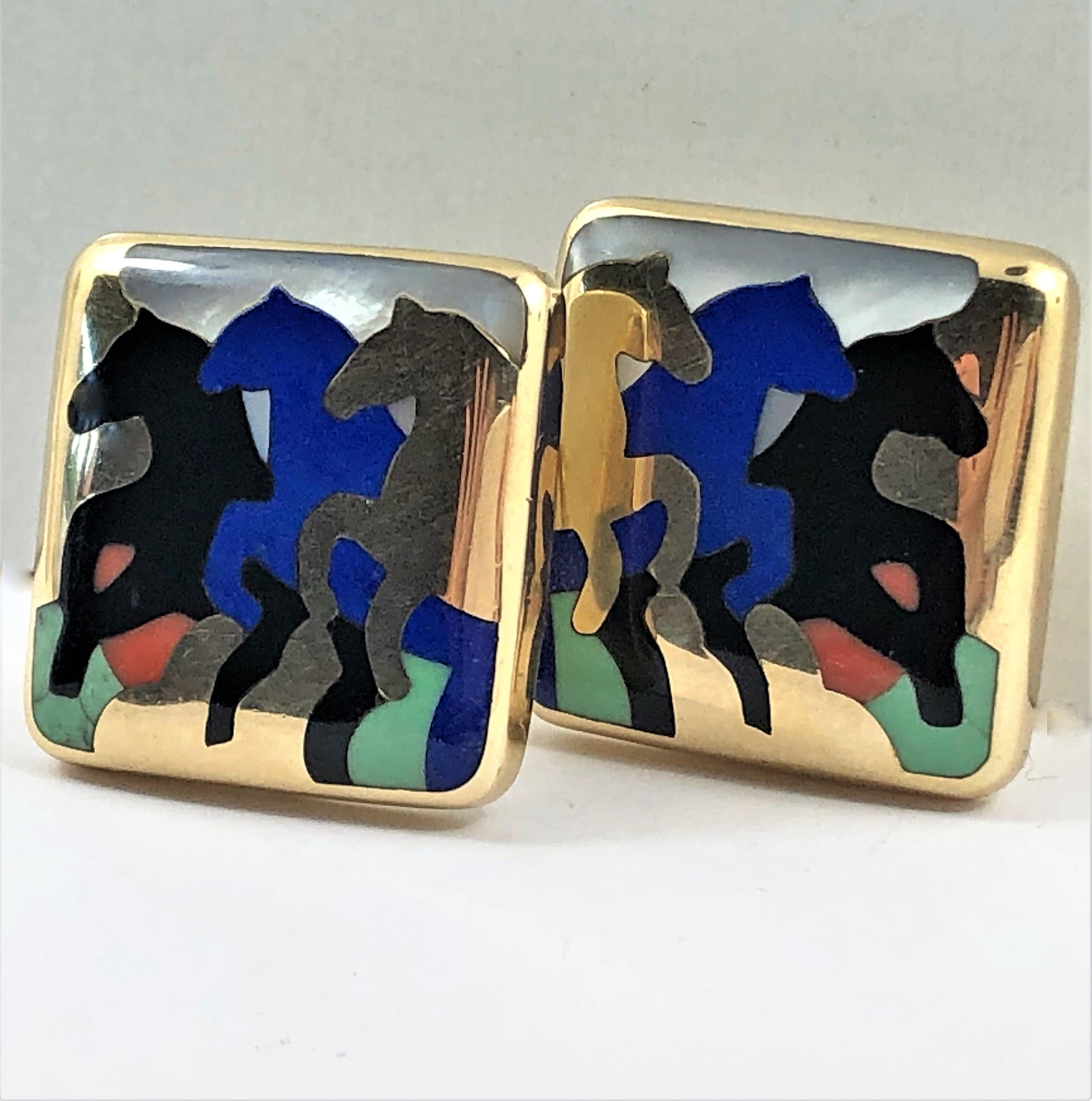 Made by Asch Grossbardt in 14K Yellow Gold, inlaid with hand cut and polished lapis lazuli, mother of pearl, aventurine, coral and onyx. Measuring 1 inch by 1 inch. With omega backs and posts. Gross weight 24 grams. Marks: AG Asch Grossbardt