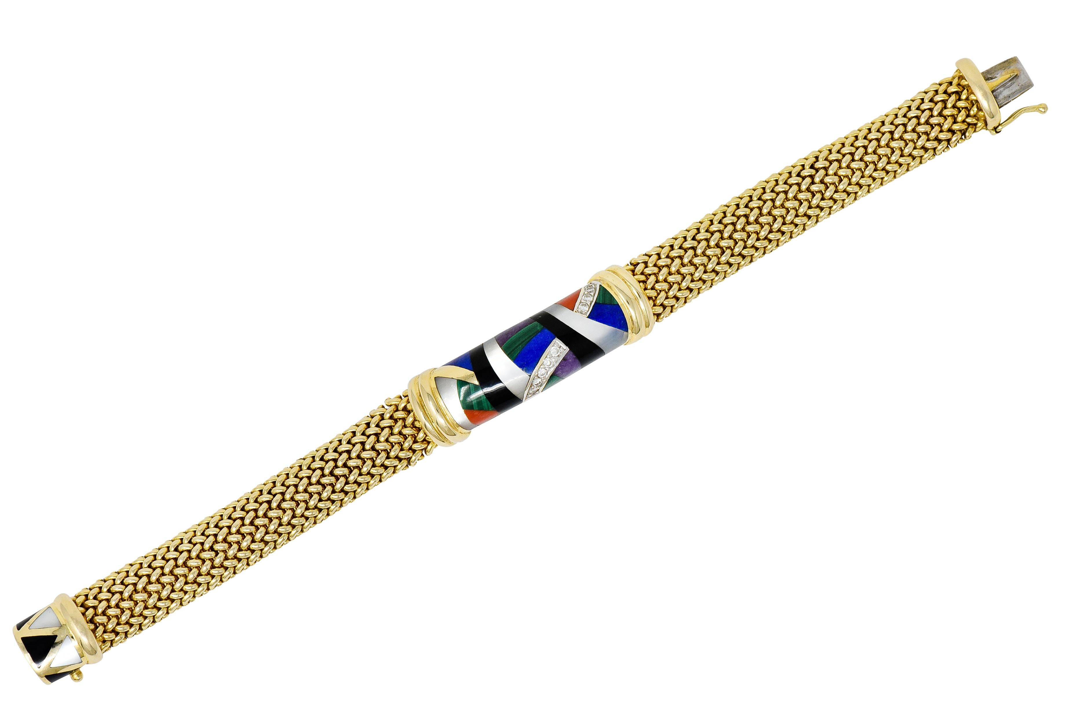 Mesh style bracelet with a central barrel shaped station with deeply ridged gold endcaps

Station is designed as an inlay mosaic of mother-of-pearl, coral, onyx, malachite, and others

Accented by a waved row of round brilliant cut diamonds weighing