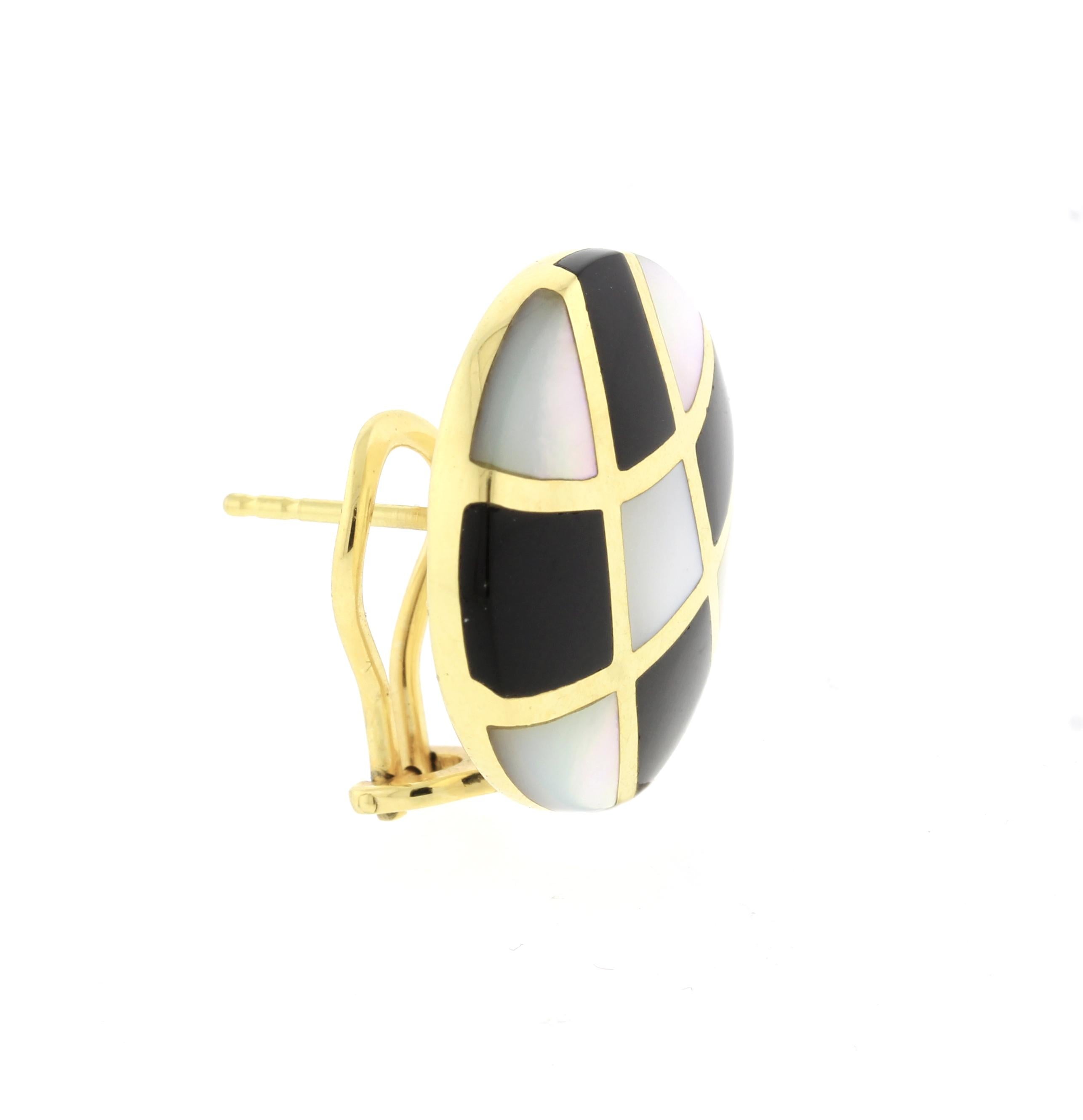 From American designer Asch Grossbardt a pair of inlaid mother of pearl and black onyx  14 karat earring. The earring  feature removeable post allowing them to be worn as clip or clip post.    7/8 of an inch diameter.
 