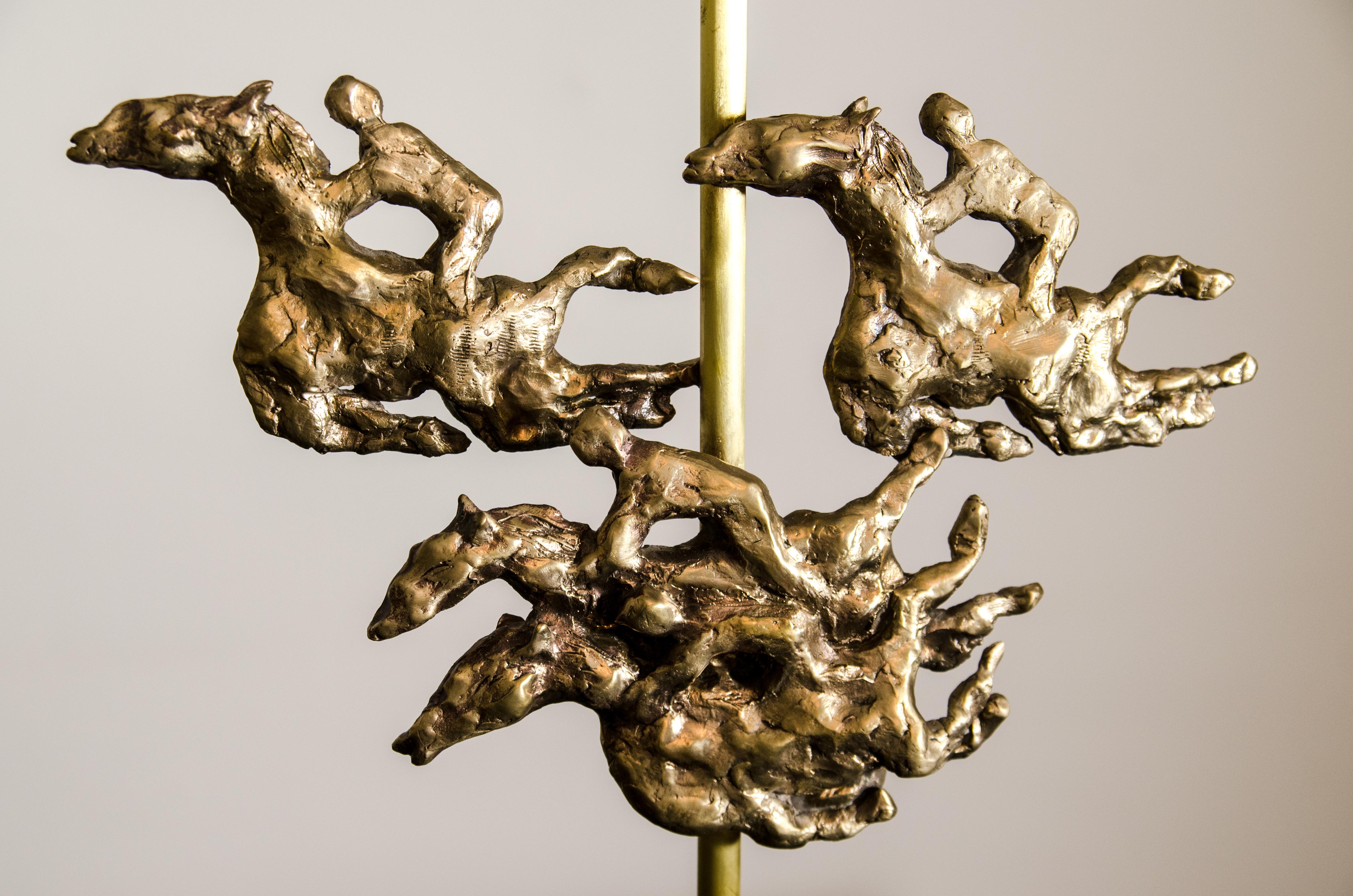 'Ascot' , one of a kind bronze table lamp handcrafted by Rinat Design and cast in bronze in the lost wax process.
Inspired by Royal Ascot, the sculpture represents the majestic movement of the horses exemplified by the stallions' legs, permanently