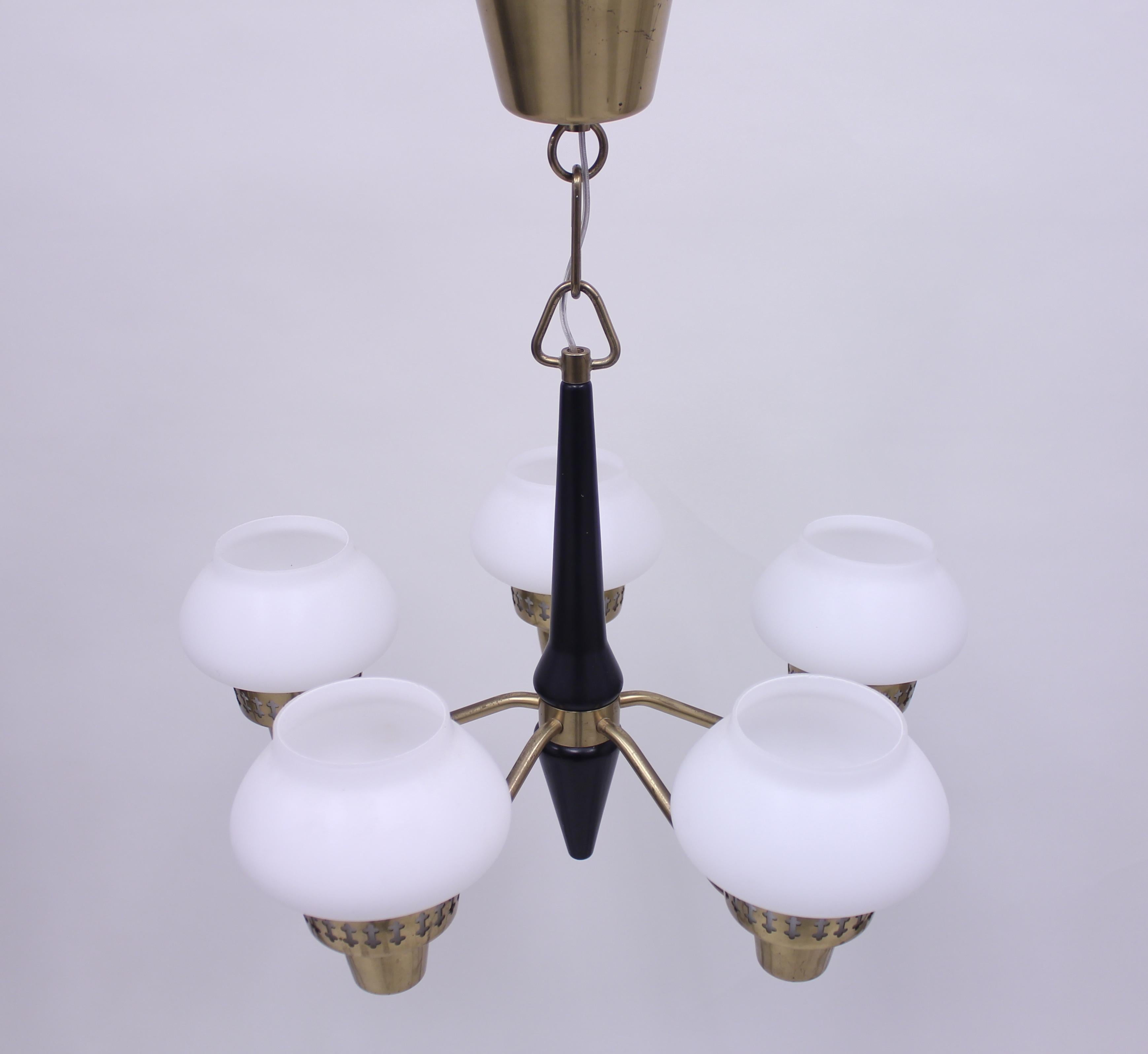 Five-light ceiling lamp manufactured by ASEA in the 1950s. Attributed to Hans Bergström who has designed many models for the brand. Lathed stem of black painted wood, brass fittings with opaline glass shades. New wiring and new plug. Very good