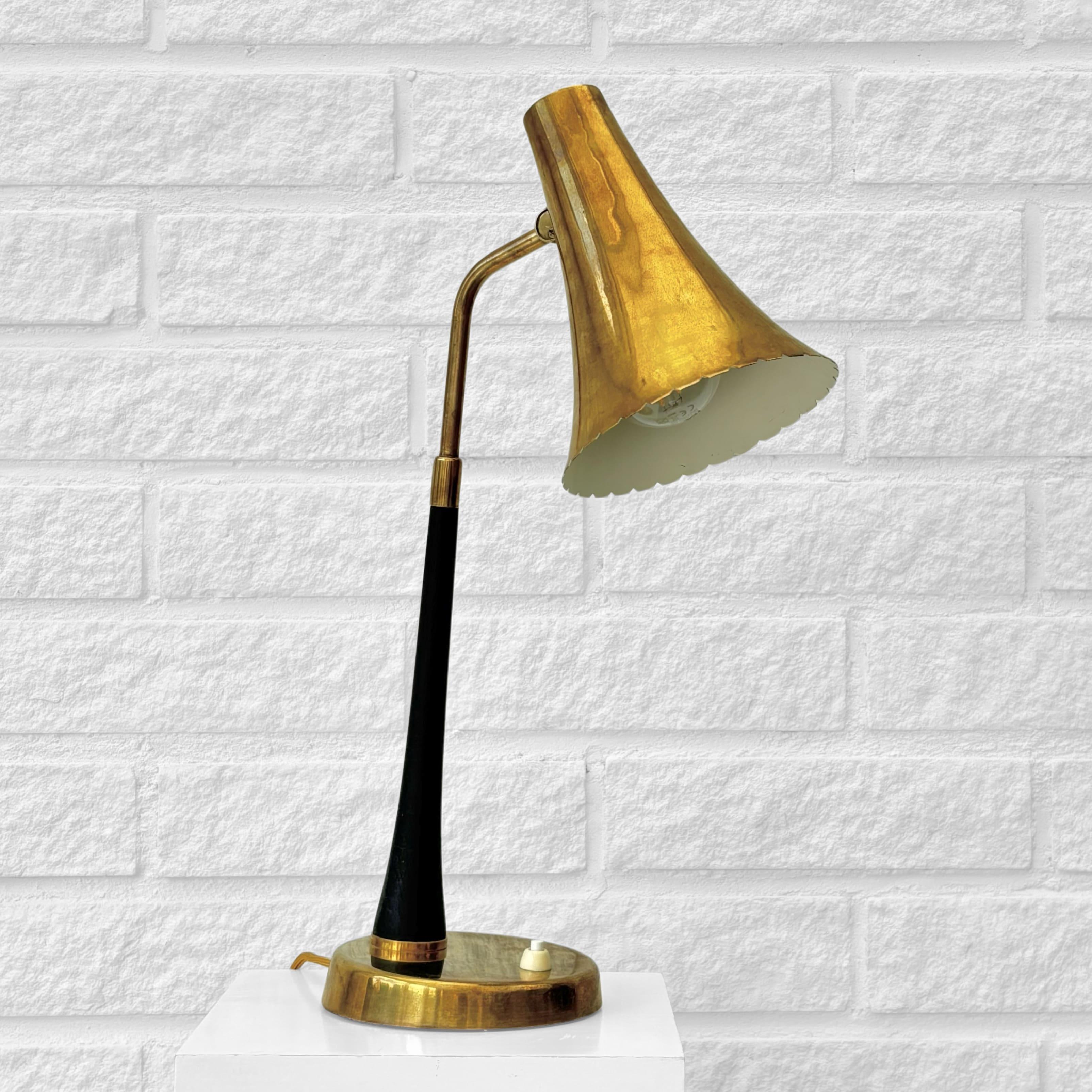 A striking example of Swedish modernist lighting design, this table lamp model E1163 was produced by the renowned manufacturer ASEA Belysning in the 1940s. Expertly crafted in solid brass, the lamp features a sculptural, flared cone-shaped shade,