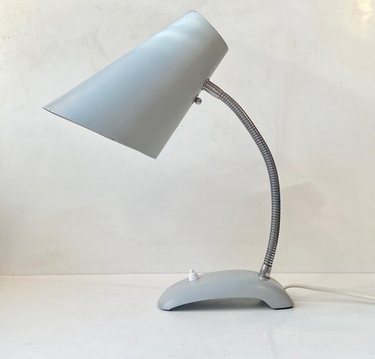 Bauhaus inspired midcentury fully adjustable desk lamp by ASEA Sweden. Made during the 1950s in a style reminiscent of Arne Jacobsen and Louis Poulsen. It is executed in powder coated steel and features a curvy/slightly concave base with on/of
