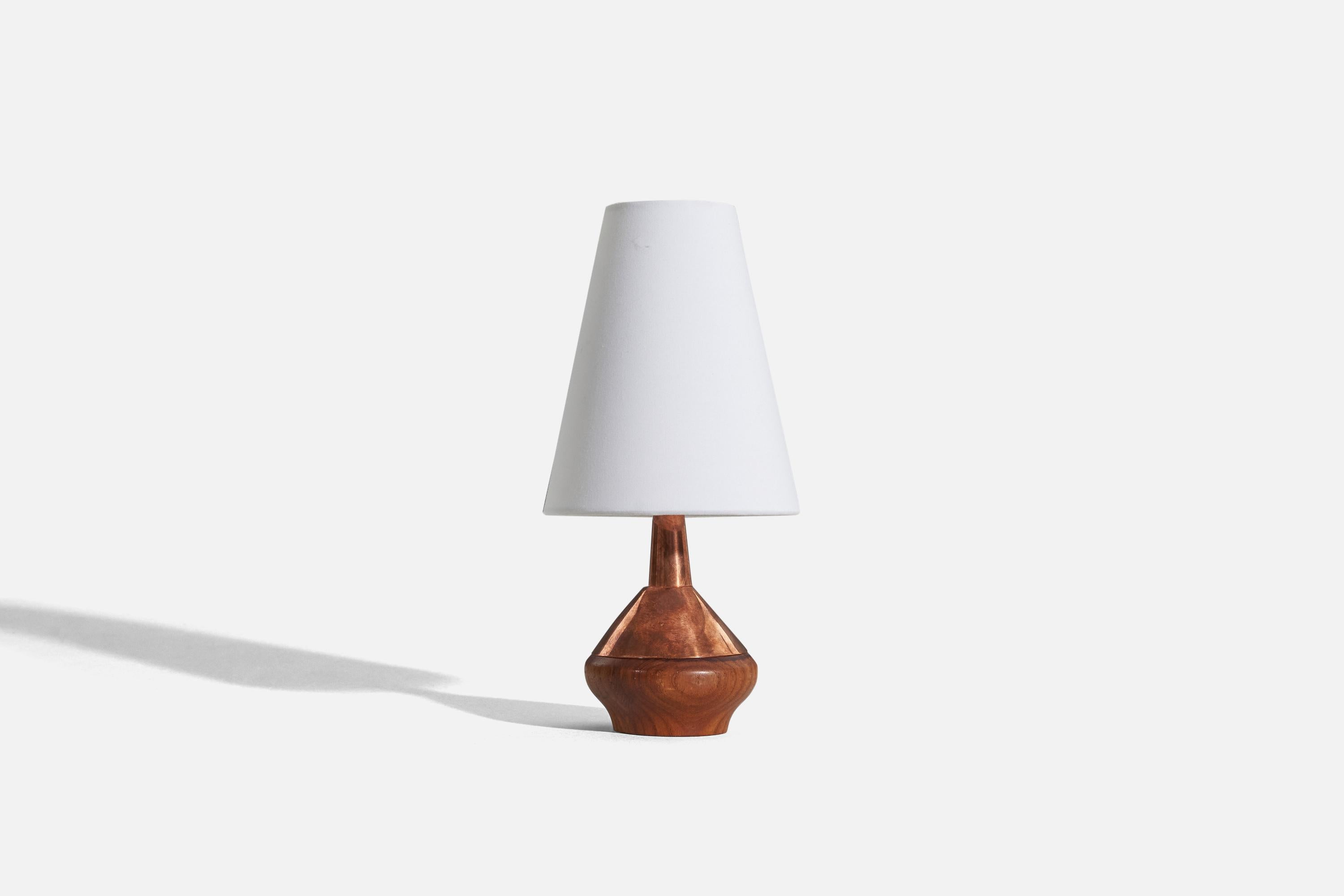 A copper and teak table lamp designed and produced by ASEA, Sweden, c. 1950s.

Sold without lampshade. 
Dimensions of lamp (inches) : 7.5 x 3.6875 x 3.6875 (H x W x D)
Dimensions of shade (inches) : 2.875 x 5.5 x 6.75 (T x B x H)
Dimension of