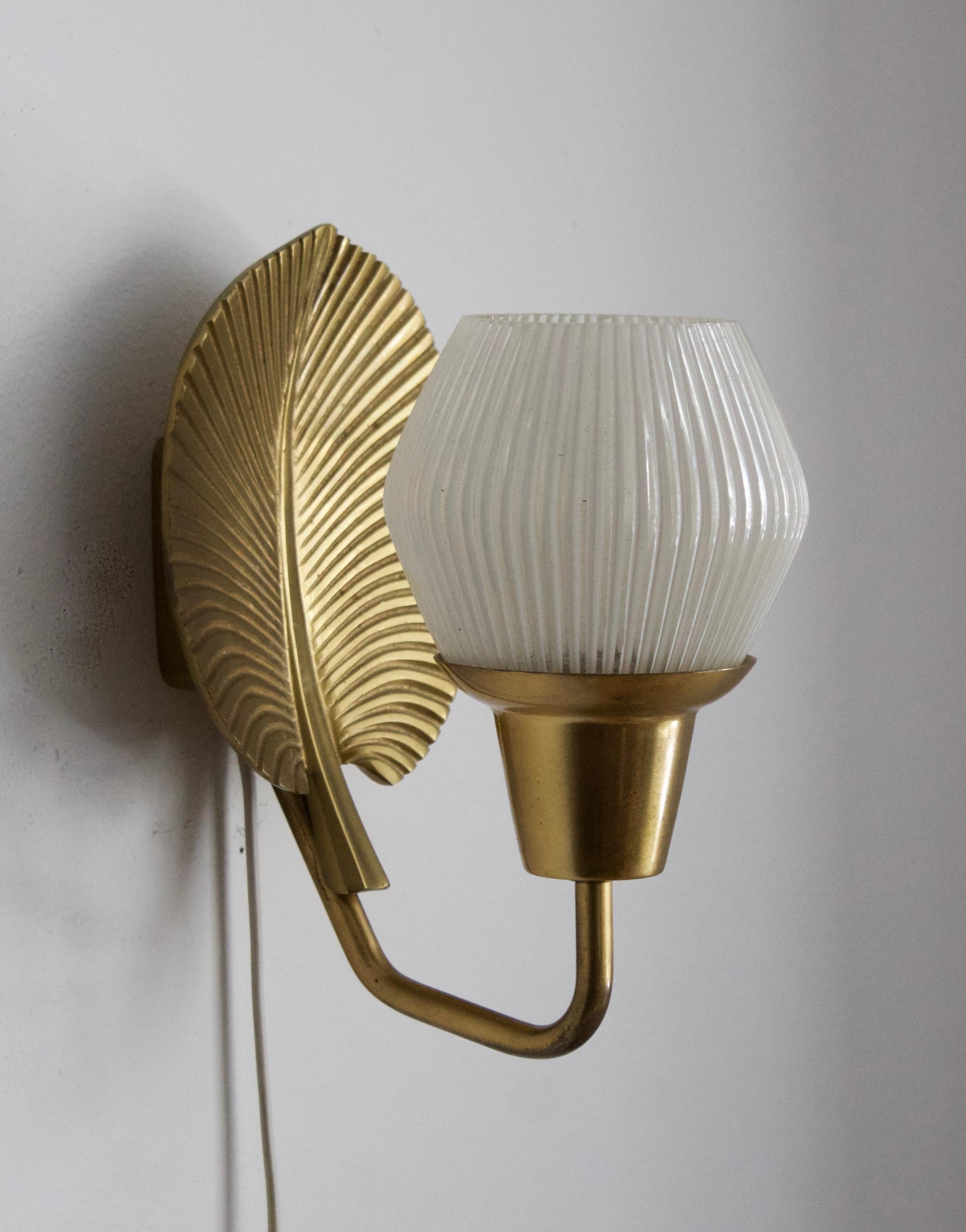 A wall light. Produced by ASEA, 1950s. Features brass and glass.

Backplate connecting to wall behind brass reflector measures 7.5 cm x 7.5 cm

Other designers of the period working in similar style include Hans Bergström, Paavo Tynell, Alvar