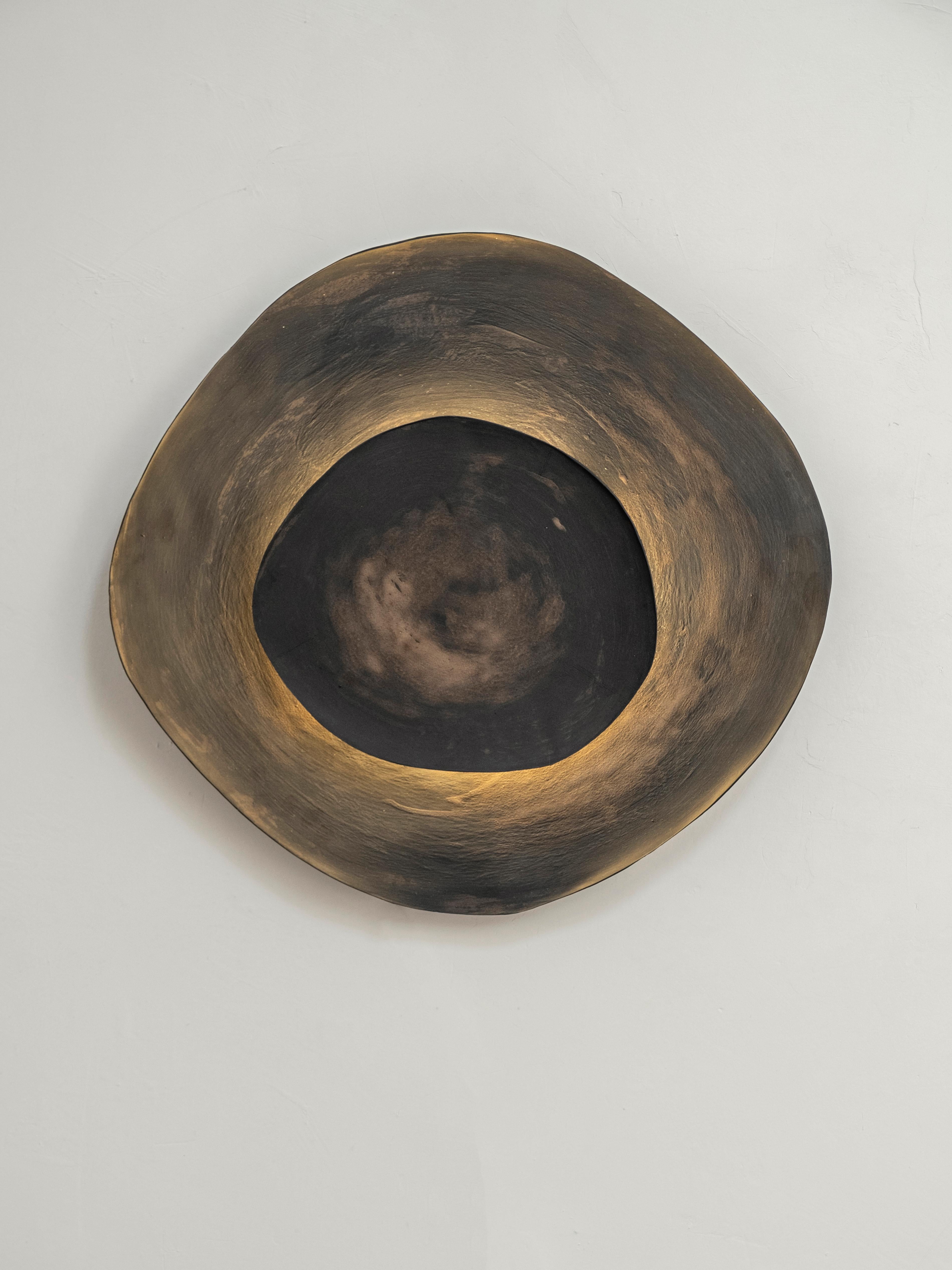 Ash #10 wall light by Margaux Leycuras.
One of a Kind, Signed and numbered.
Dimensions: Ø44 x H41 cm.
Material: Ceramic, black stoneware with burnished gold glaze.
The piece is signed, numbered and delivered with a certificate of