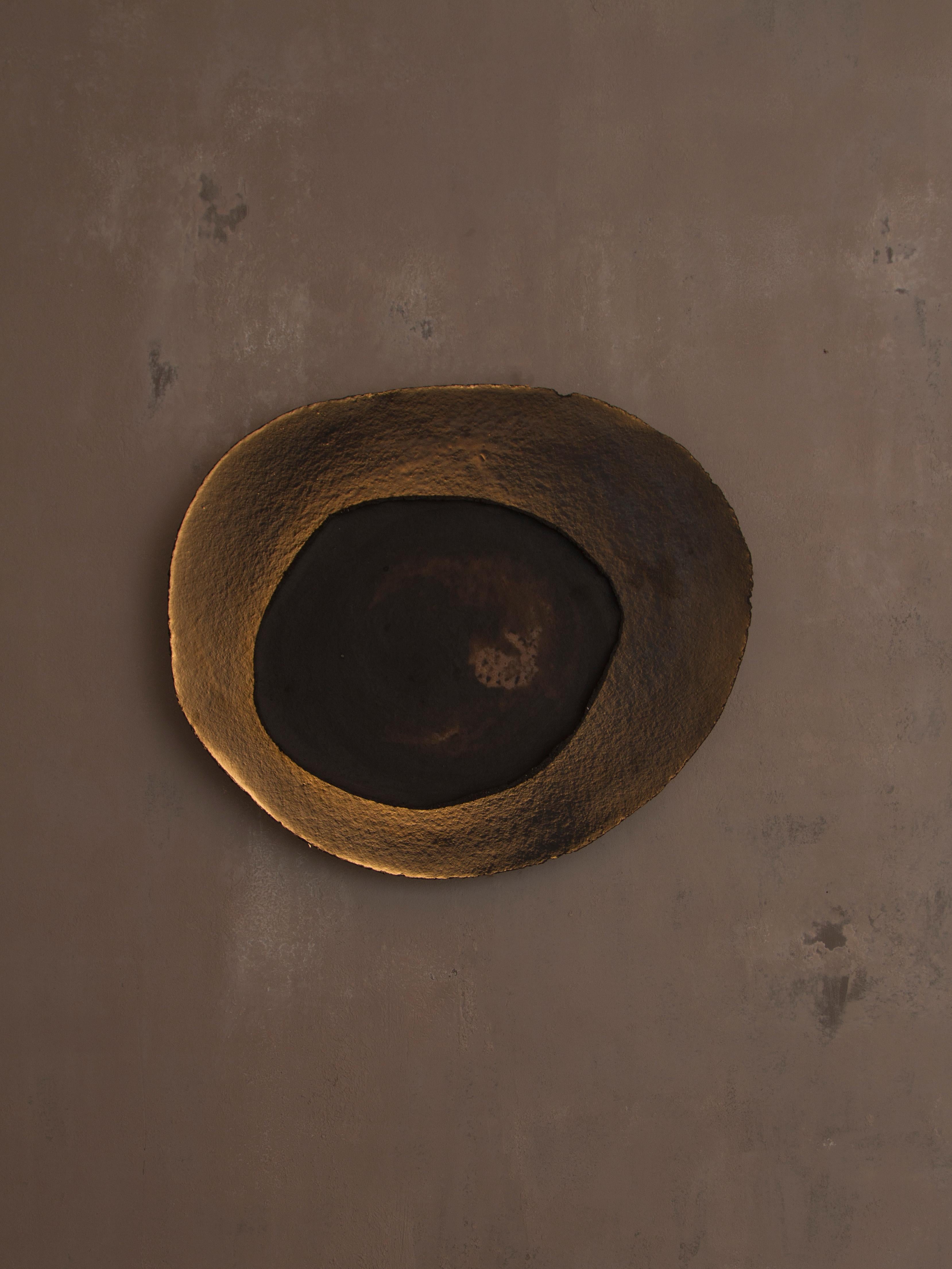Ash #6 wall light by Margaux Leycuras
One of a Kind, Signed and numbered
Dimensions: D 6 x W 56 x H 47 cm 
Material: Ceramic, black stoneware with patinated gold enamel.
The piece is signed, numbered and delivered with a certificate of