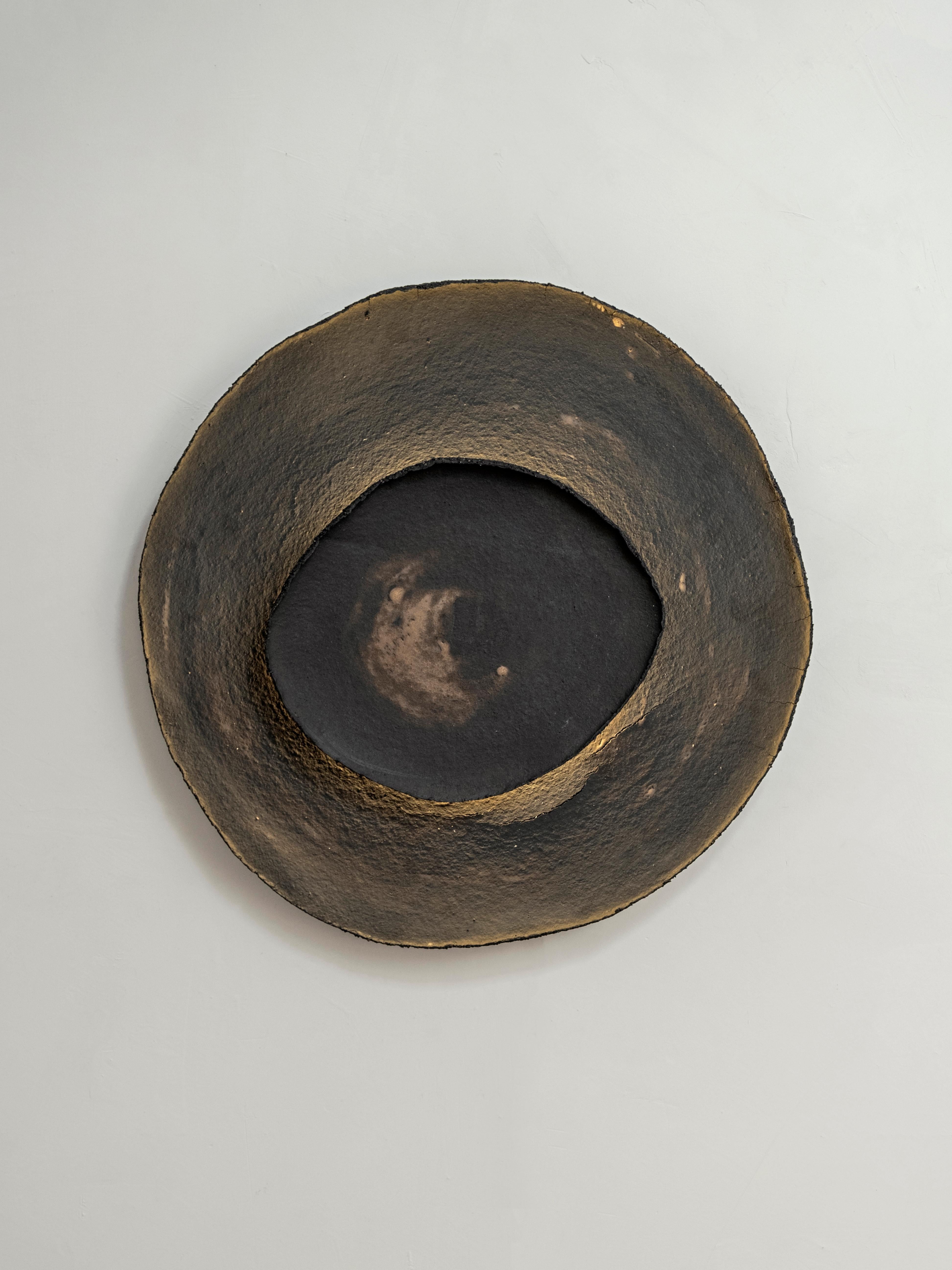 Ash #8 wall light by Margaux Leycuras.
One of a Kind, Signed and numbered.
Dimensions: Ø57 cm.
Material: Ceramic, black stoneware with burnished gold glaze.
The piece is signed, numbered and delivered with a certificate of authenticity.

The