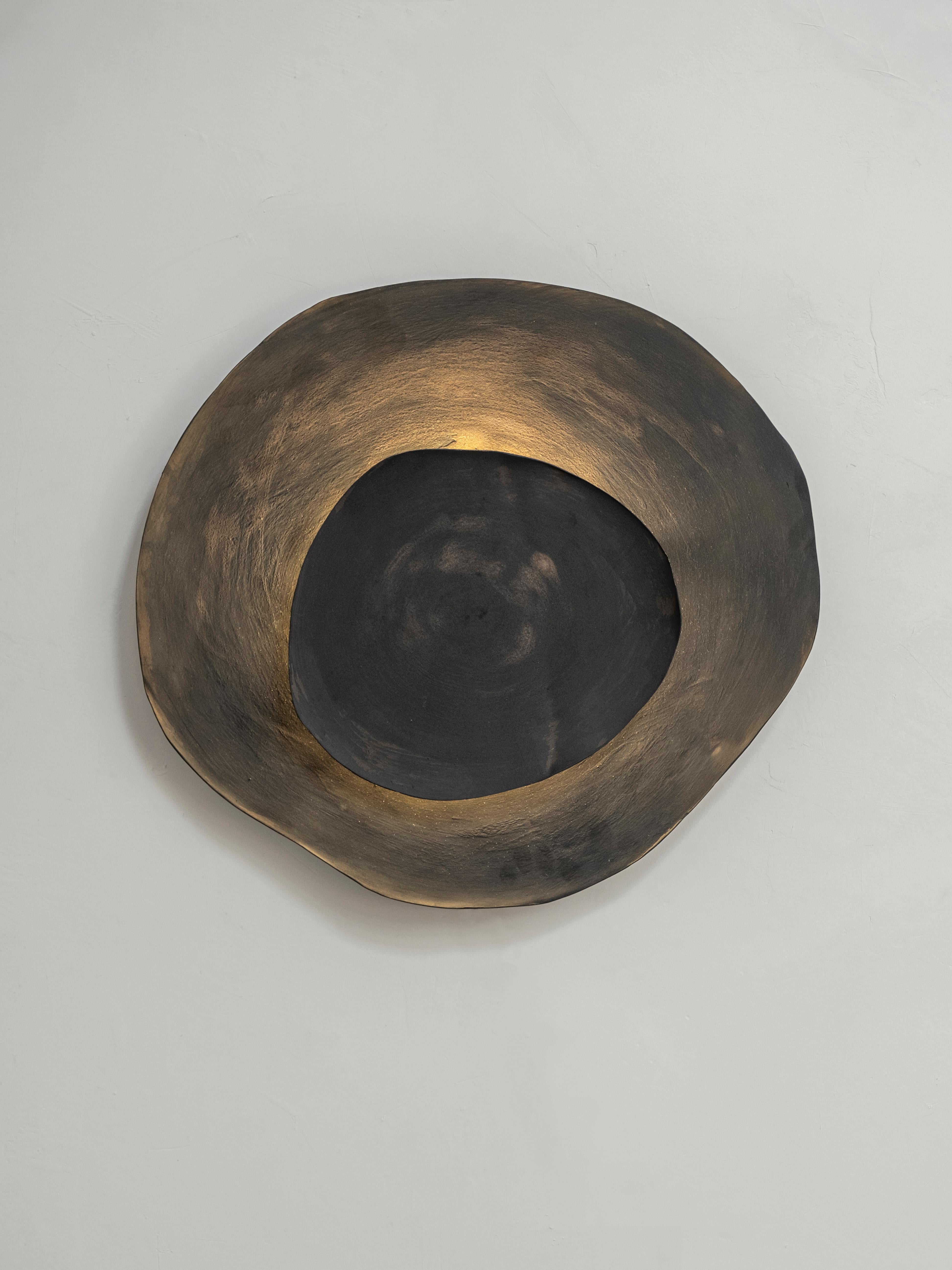 Ash #8 wall light by Margaux Leycuras.
One of a Kind, Signed and numbered.
Dimensions: Ø44 x H40 cm.
Material: Ceramic, black stoneware with burnished gold glaze.
The piece is signed, numbered and delivered with a certificate of