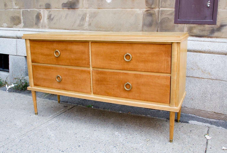 Stylish ash four-drawer commode by Baptistin Spade. A beautiful 1940s design inspired by the Classic French Directoire style, the four drawers are covered with leather and fitted with gilt bronze pulls.