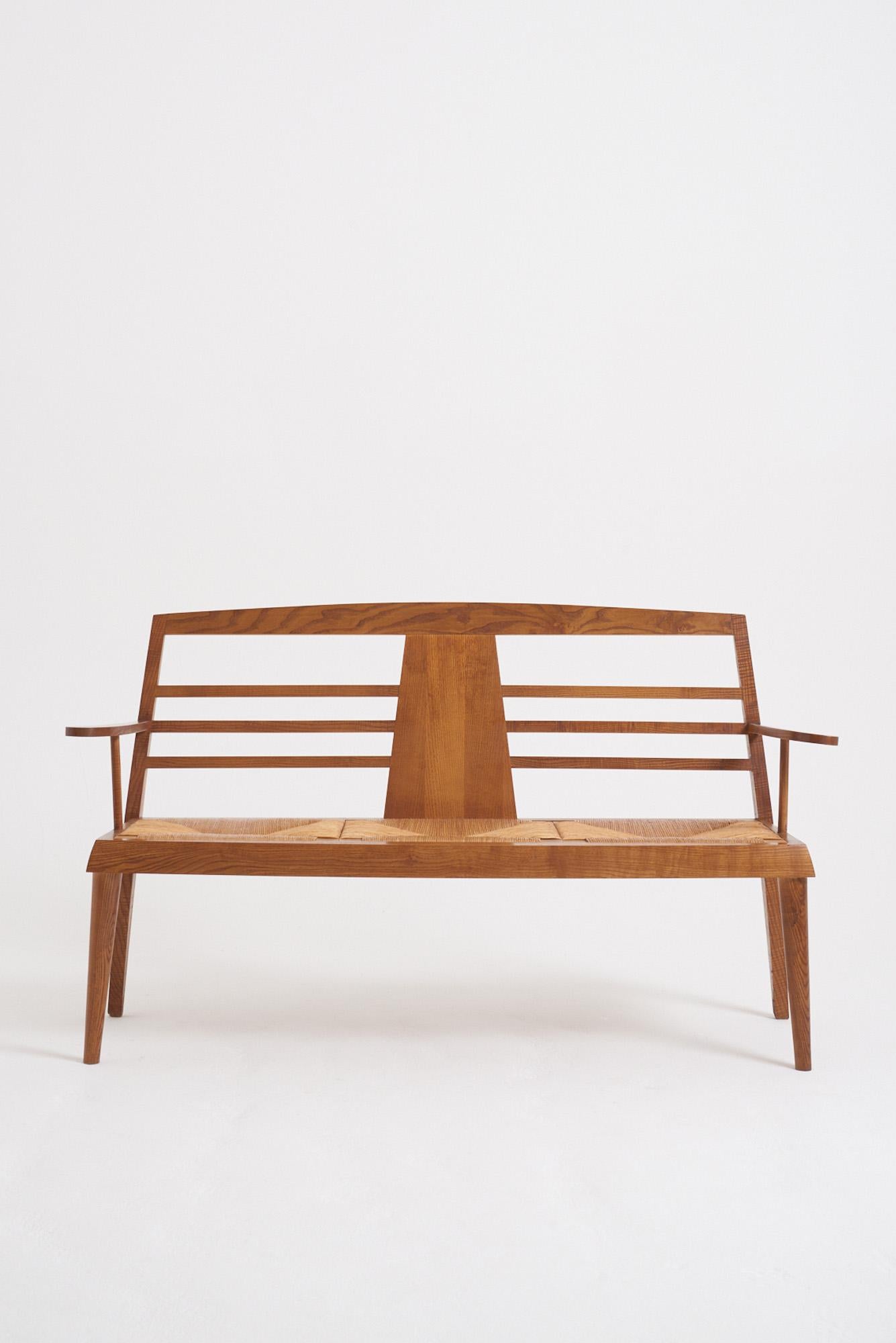 An ash and rush seat banquette
France, 1970-80s