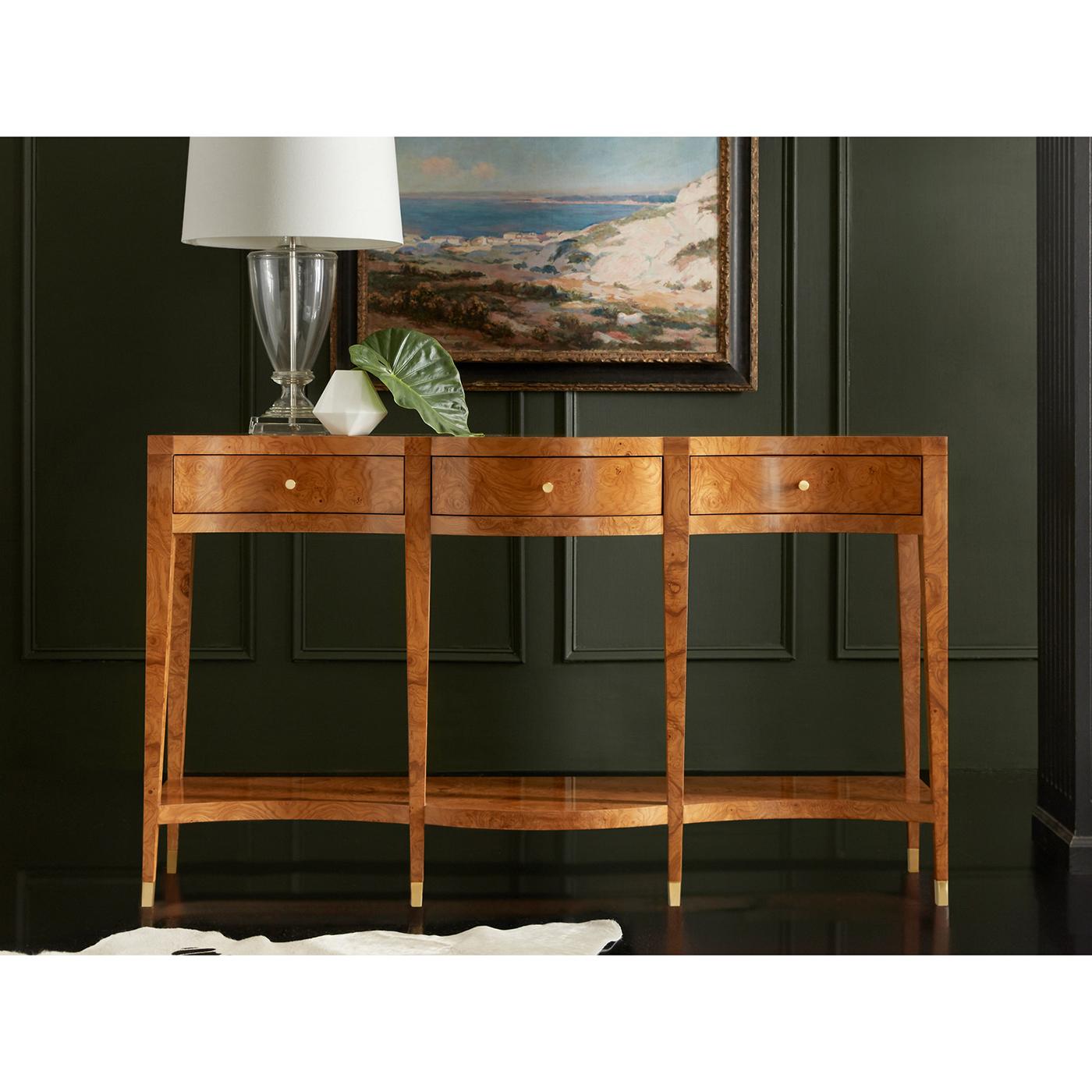 Crafted from exquisite Ash Burl veneer, this console table features a gracefully curved serpentine silhouette that highlights its intricate wood grain patterns and warm, golden tones. With three spacious drawers and a lower shelf, it offers