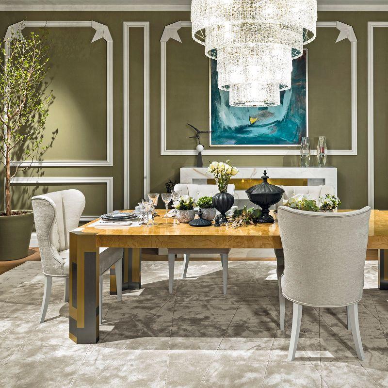 A magnificent showcase of craftsmanship, this rectangular dining table is fashioned of ash burl enhanced with inlay. Resting on brass and steel legs, the top is defined by a striking textural and visual effect of singular value. Please inquire for