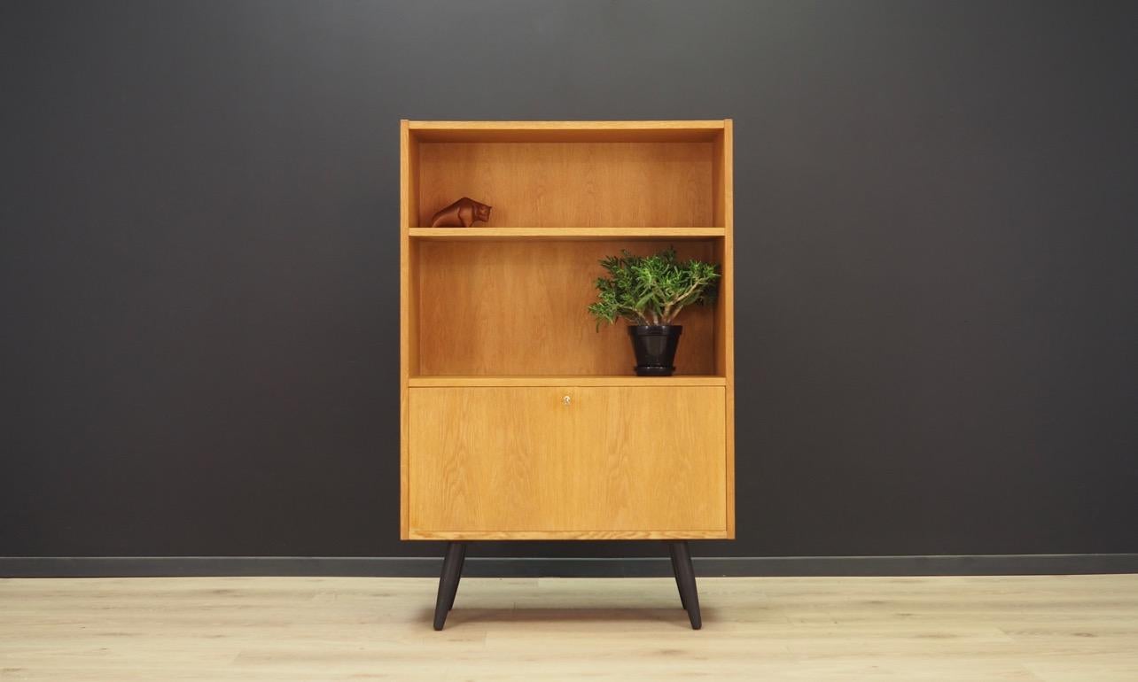 Original cabinet from the 1960s-1970s, minimalistic form - Danish design. The form is veneered with ash. A spacious bar behind the door, and a bookshelf. The lock works on magnetism, the key is used to facilitate the opening of the door. Preserved