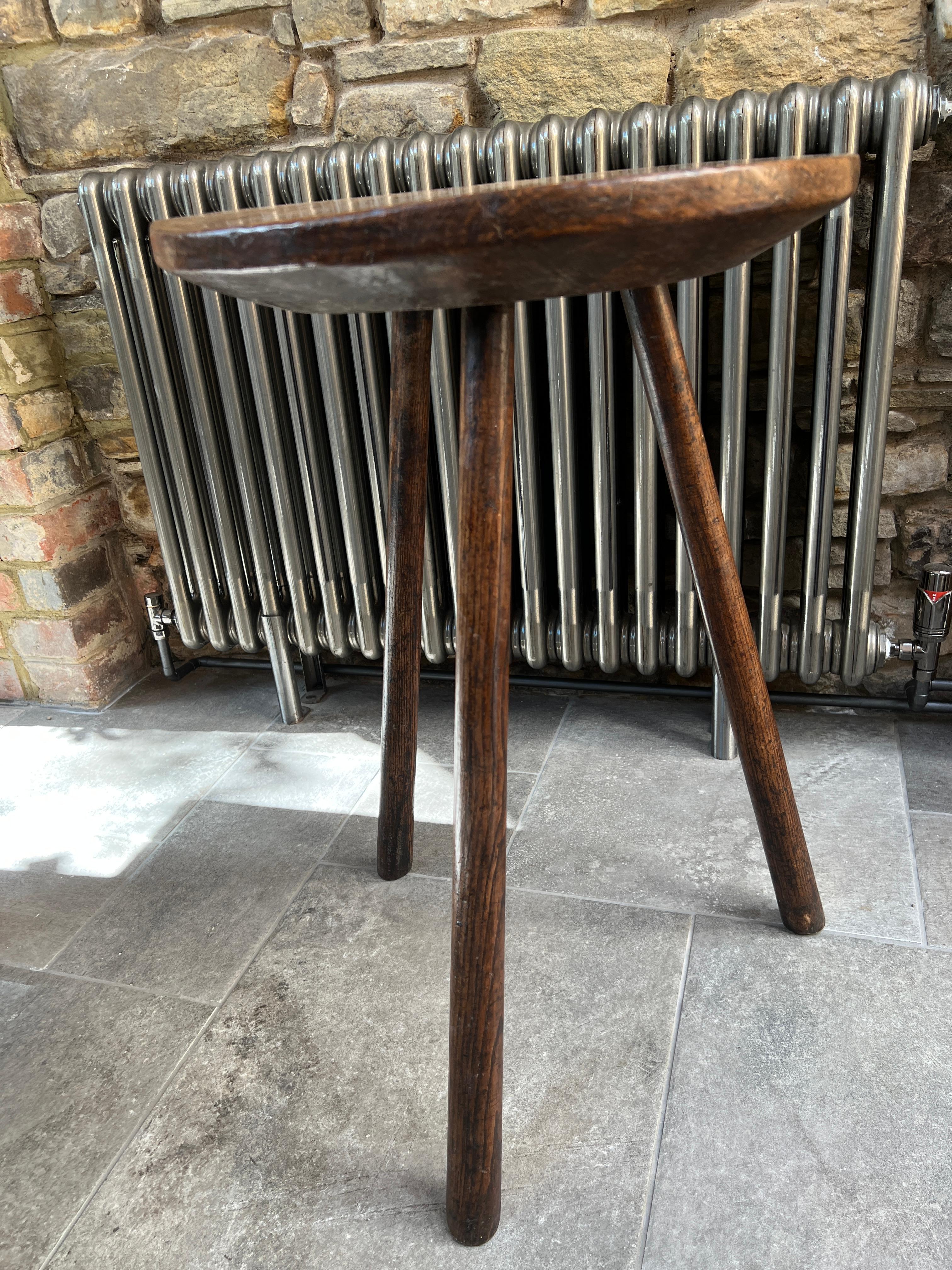 A very elegant and rare Ash cricket table, with a generous one piece, thick, richly patinated slab top of glorious colour.  The table is supported on three simple tapering stick legs.  All in good original condition.  Late 19th Century Ash Cricket