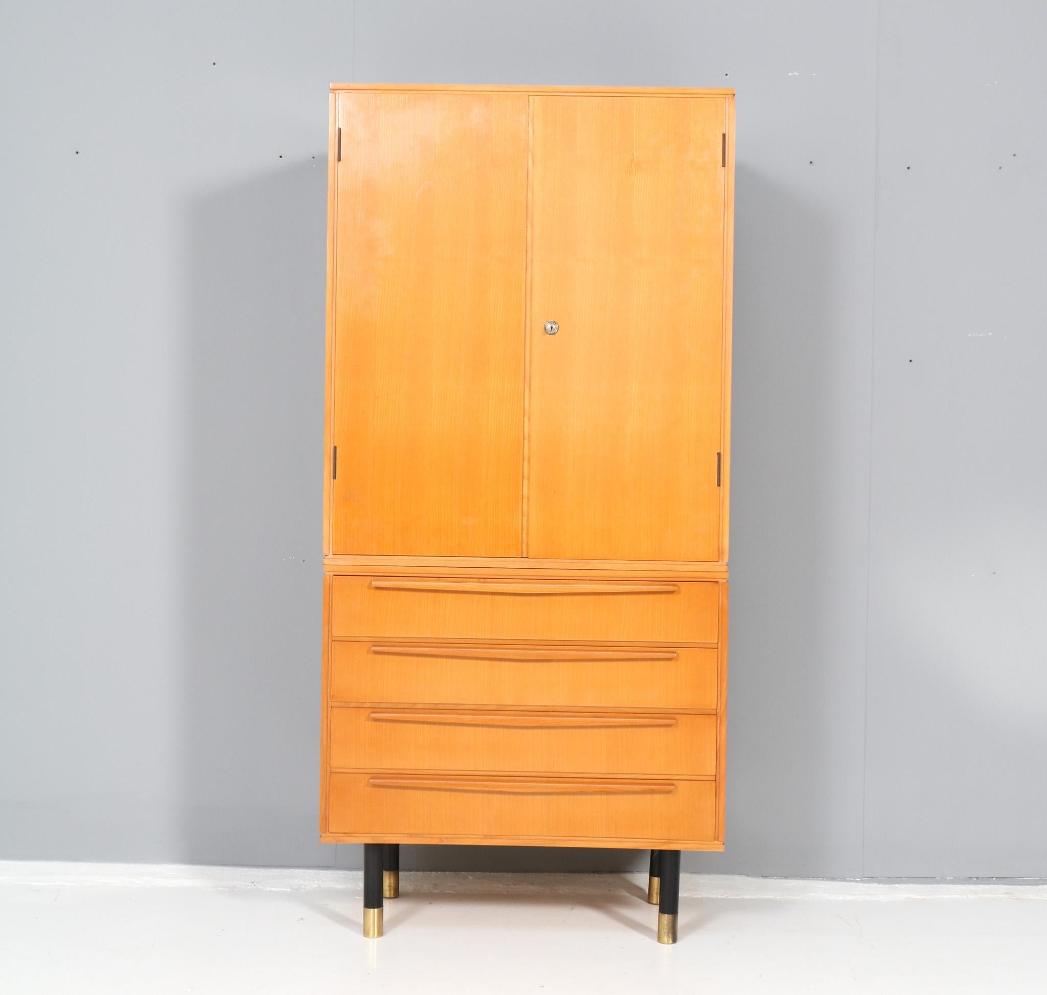 Stunning and rare Mid-Century Modern two-piece cabinet.
Striking Italian design from the 1950s.
Original ash veneered base with three drawers and original ash veneered top with two doors.
On original black lacquered feet with original patinated
