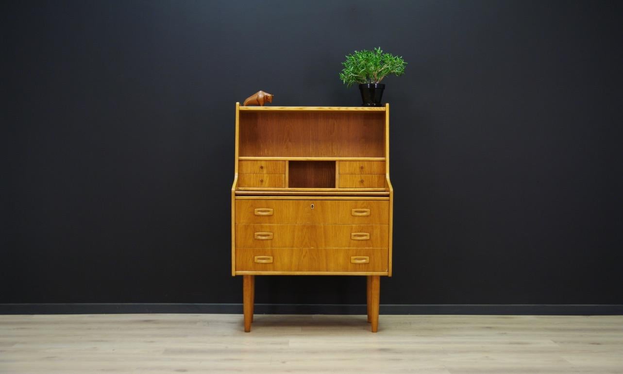Phenomenal secretary from the 1960s-1970s, brilliant form finished with ash veneer. Item has a retractable top and numerous drawers. Preserved in good condition (small bruises and scratches, dark stain on the counter) - directly for