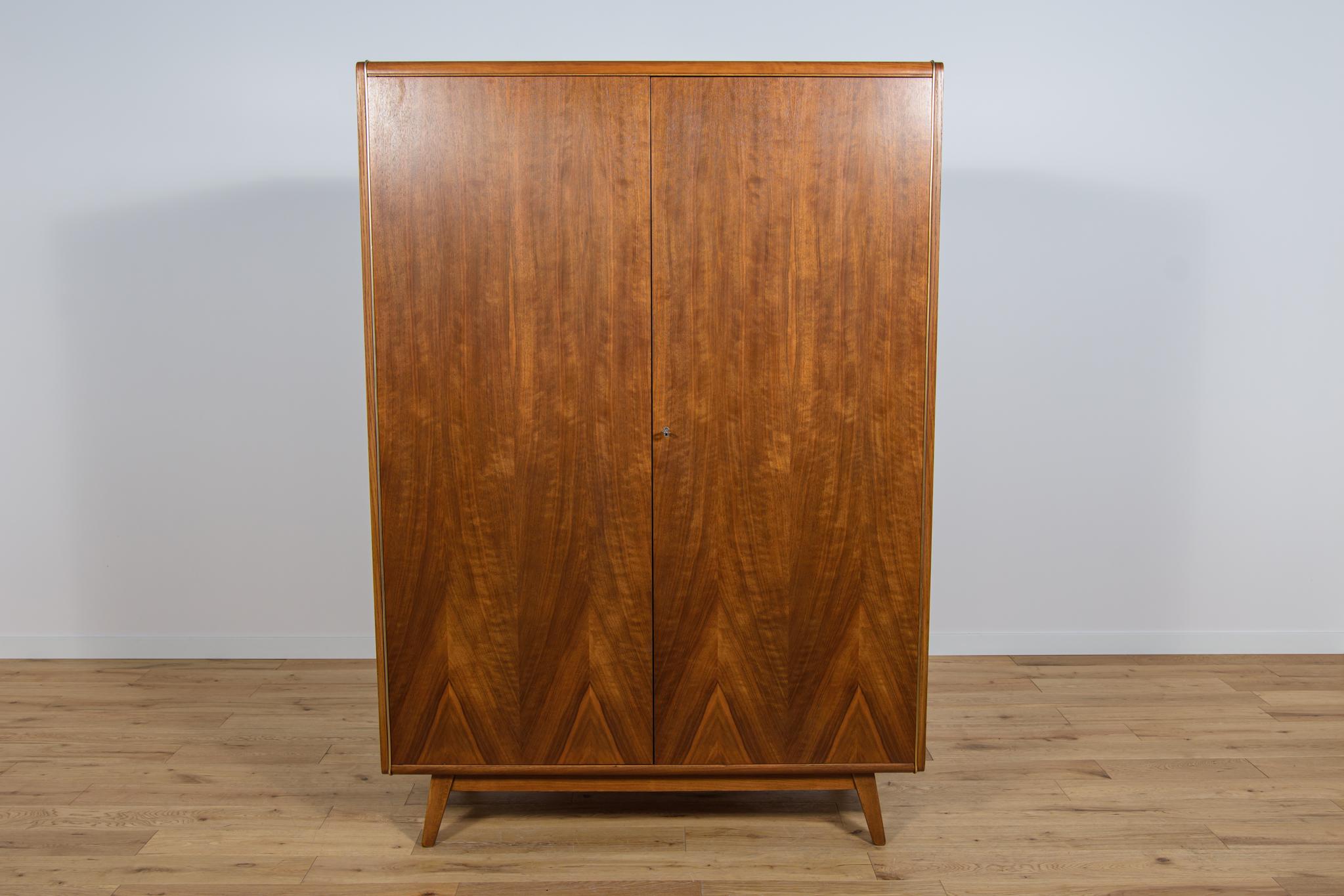 A wardrobe designed by Bohumil Landsman in the 1960s and manufactured by the Jiton Soběslav furniture factory in Czechoslovakia. Wardrobe fronts are made of interestingly grained walnut veneer, sides veneered with ash. Solid beech wood elements. The