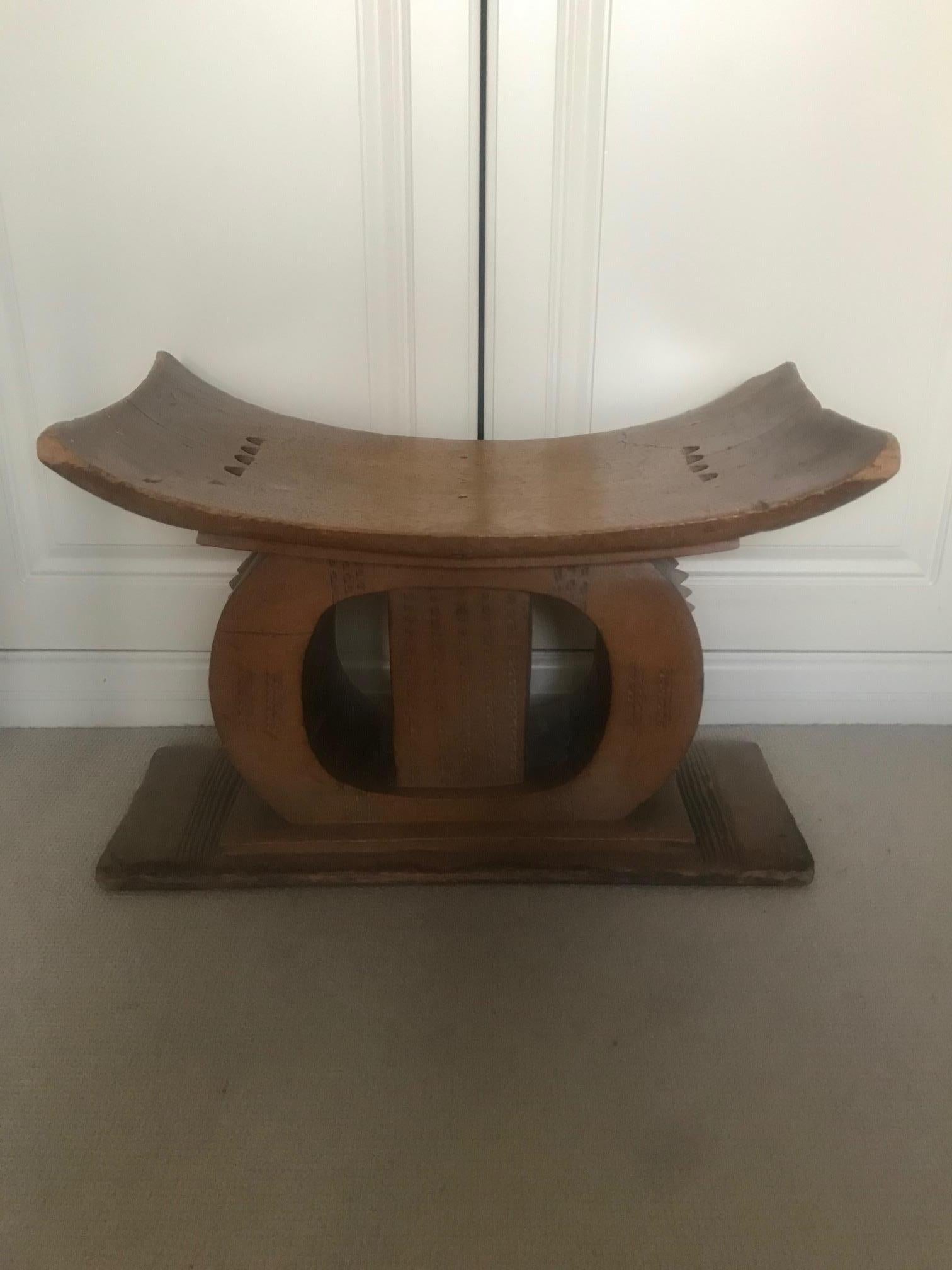 A mid-20th century tribal stool. Carved from one piece of wood, this stool was made by the Ashanti tribe from Ghana. Good patination and signs of genuine use.