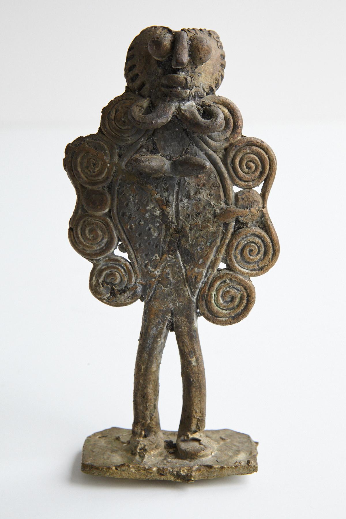 Akan Ashanti cast bronze figurine. The Ashanti or Asante People from Ghana have a rich tradition of crafting bronze pieces to commemorate important figures from their culture or people from their tribe or family. 
The figurines are usually made