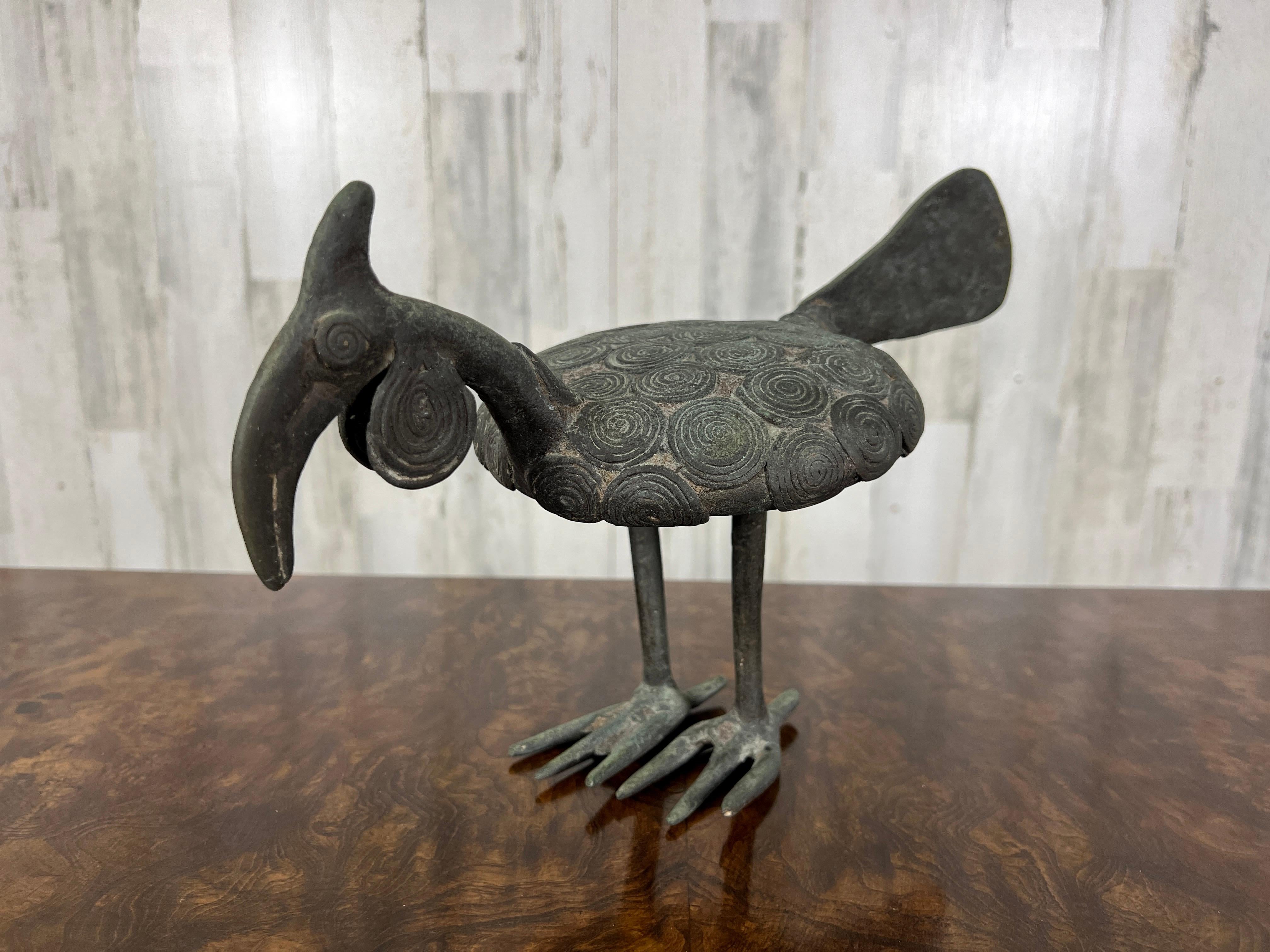 The Ashanti people of Ghana, West Africa, are recognized for their detailed bronze artworks like statues and figurines.
This bronze statue depicts the African Hornbill, a bird native to West and Central Africa. The Ashanti have a rich tradition of