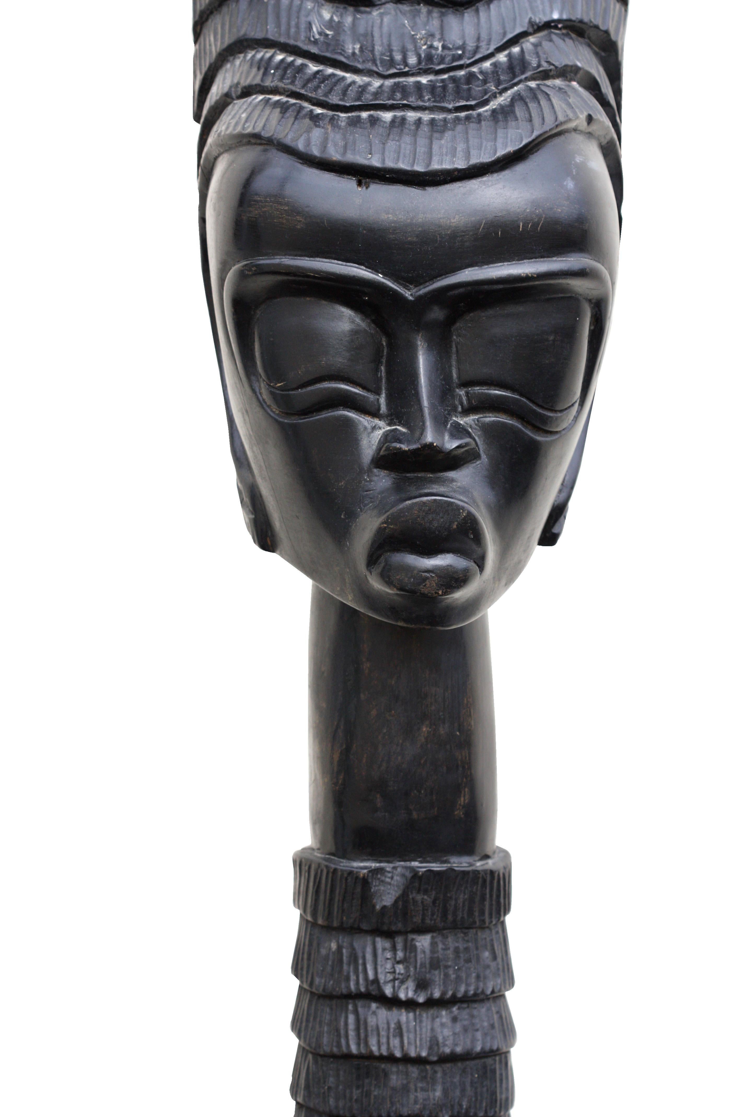 Ashanti female head, Ghana style
Measures: Height 43 in (109.2 cm.), width 8.25 in. (20.95 cm.), base width 7.75 in. (19.68 cm.), base depth 9.18 in. (23.33 cm.).