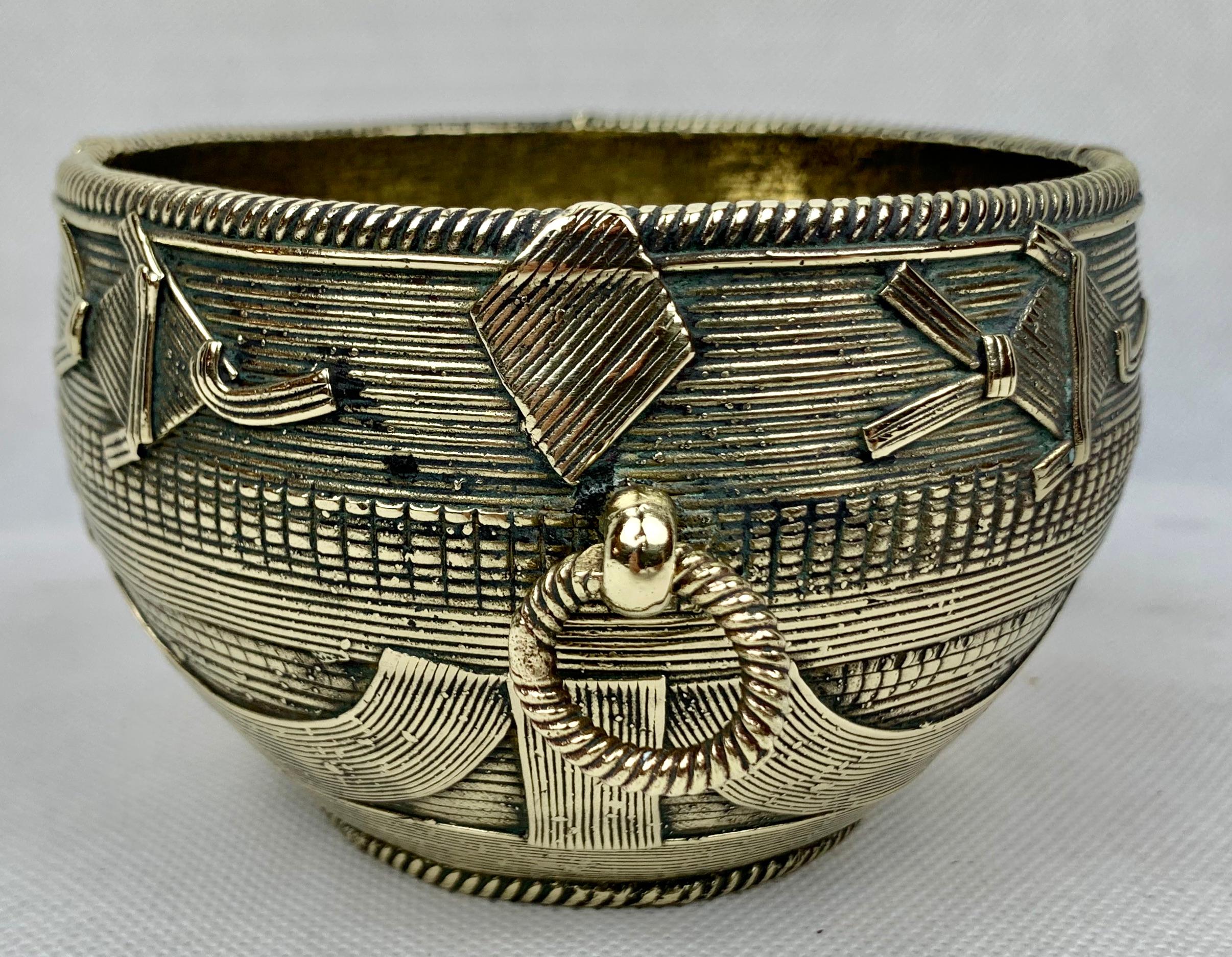 Ashanti vintage solid bronze bowl with ring handles. The bowl has great definition in the form of a basket. The top border has fish shapes just under the rim.
The Ashanti Akan people were known to work with bronze in the lost wax method.
Measures:
