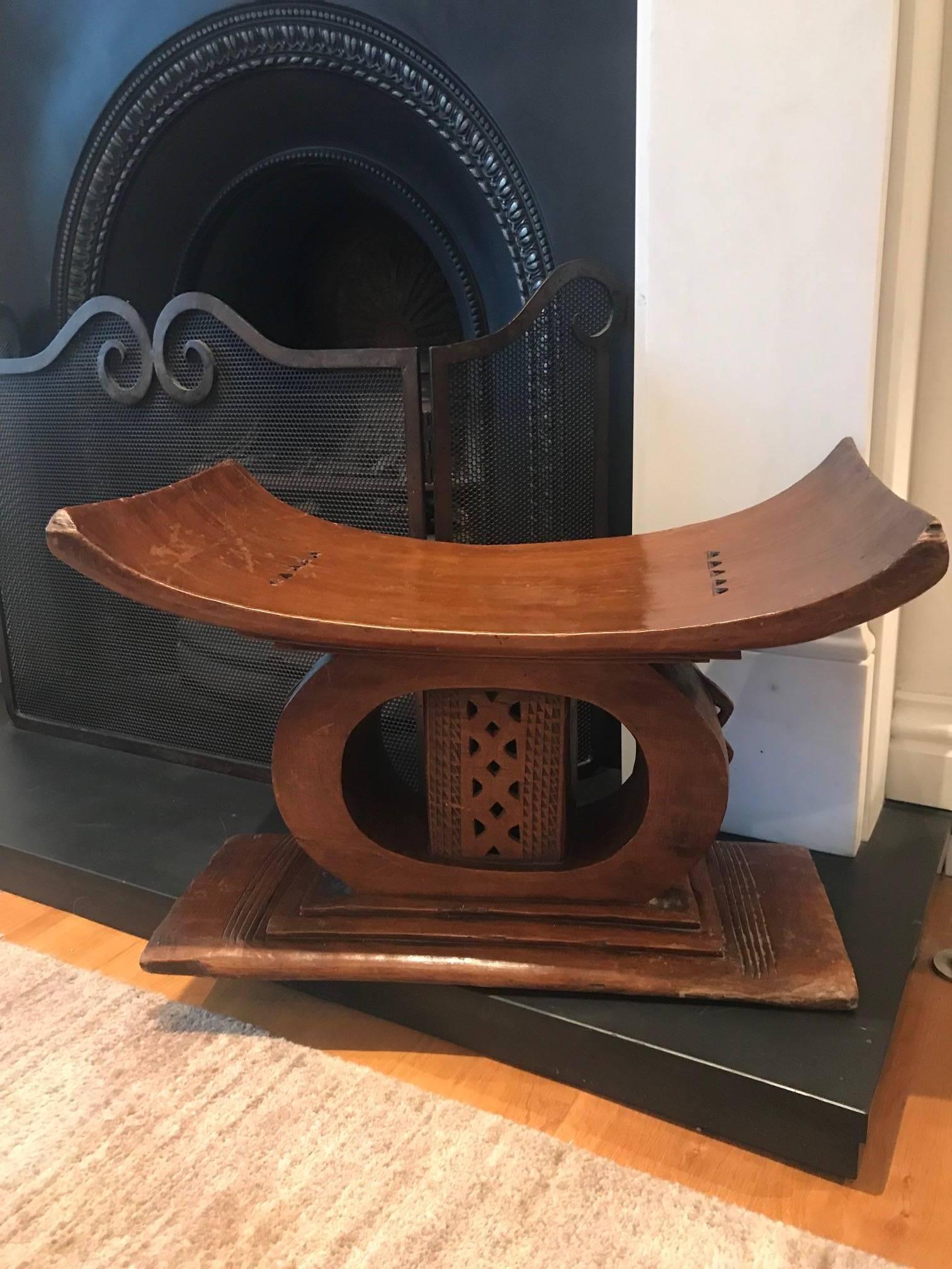 A good example of an African stool featuring interesting geometric carving. The stool has been used and there is obvious signs of wear and tear including a split in the wood and one of the small carvings on the side has been knocked off.
   