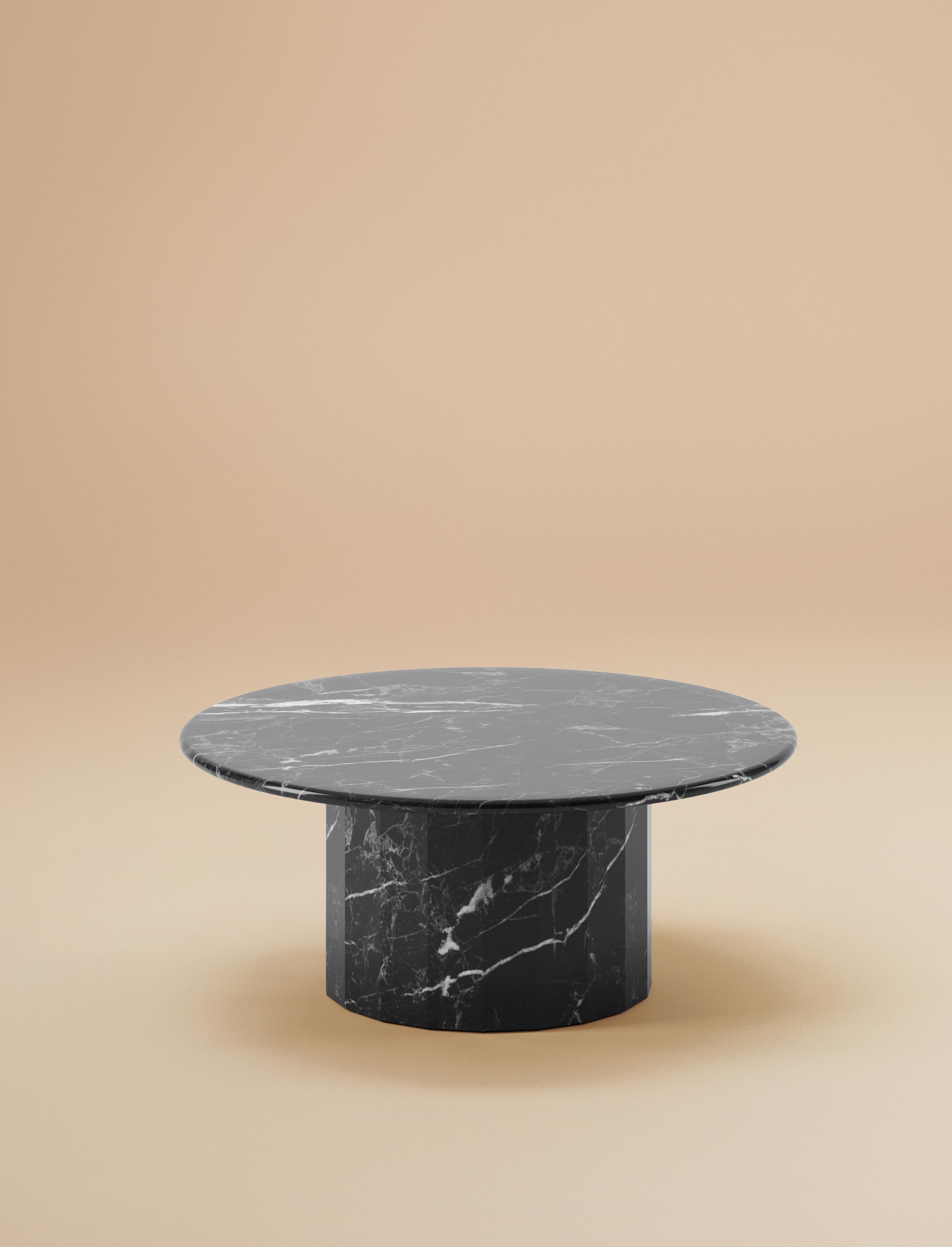 The Ashby round coffee table stands as a testament to Lemon's commitment to embracing simplicity. Inspired by the beauty of marble, its slim round top harmonizes elegantly with a sturdy faceted base—a deliberate and defining design element.