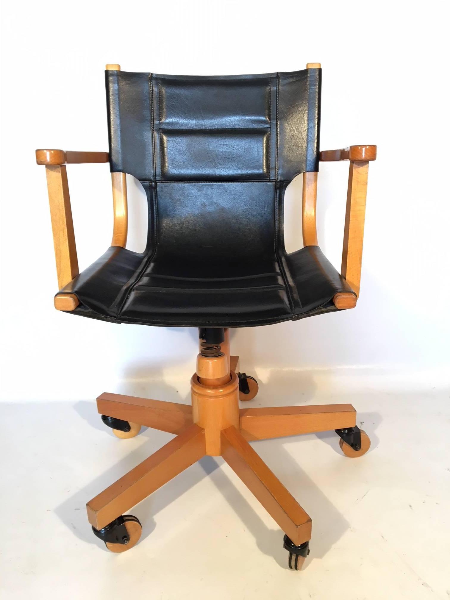 Midcentury swivel office chair by Asher Benjamin Studio features black leather and light hardwood frame. Adjustable hydraulic lifting and rocking seat. Good vintage condition with minor age appropriate wear. Measures: 23